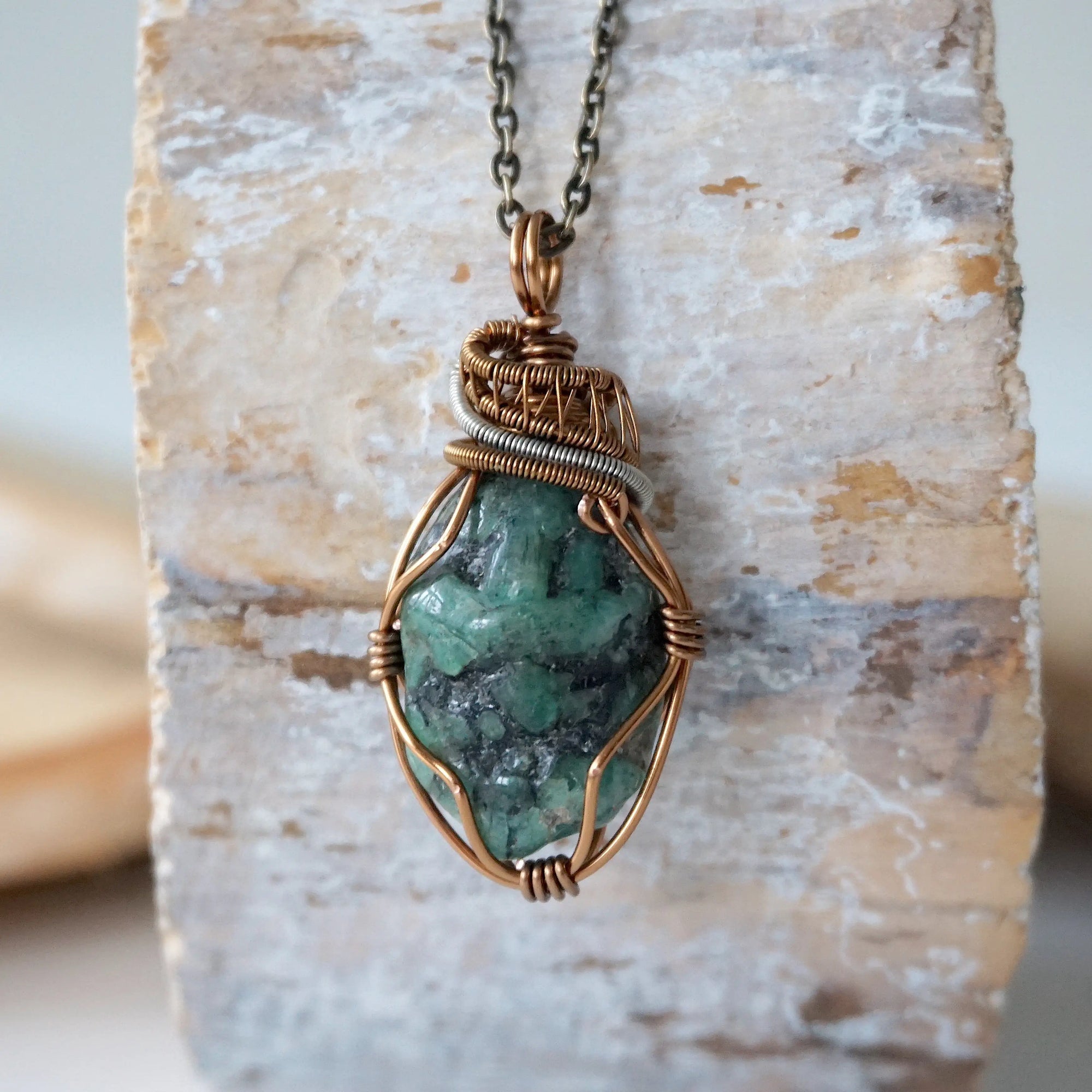 Handcrafted raw emerald necklace front view – artisan bronze and silver copper wire wrapping, May birthstone jewelry for all genders, Designs by Nature Gems.