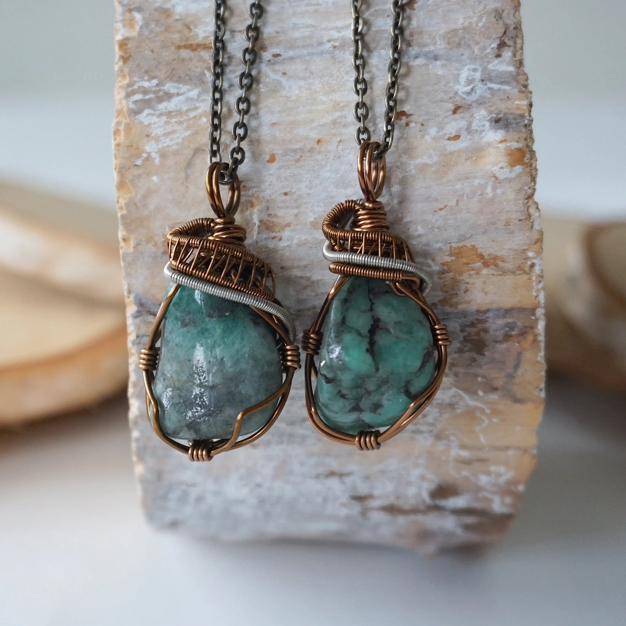 Two raw emerald pendants – displaying unique differences in natural emerald crystals, wire-wrapped for all genders.