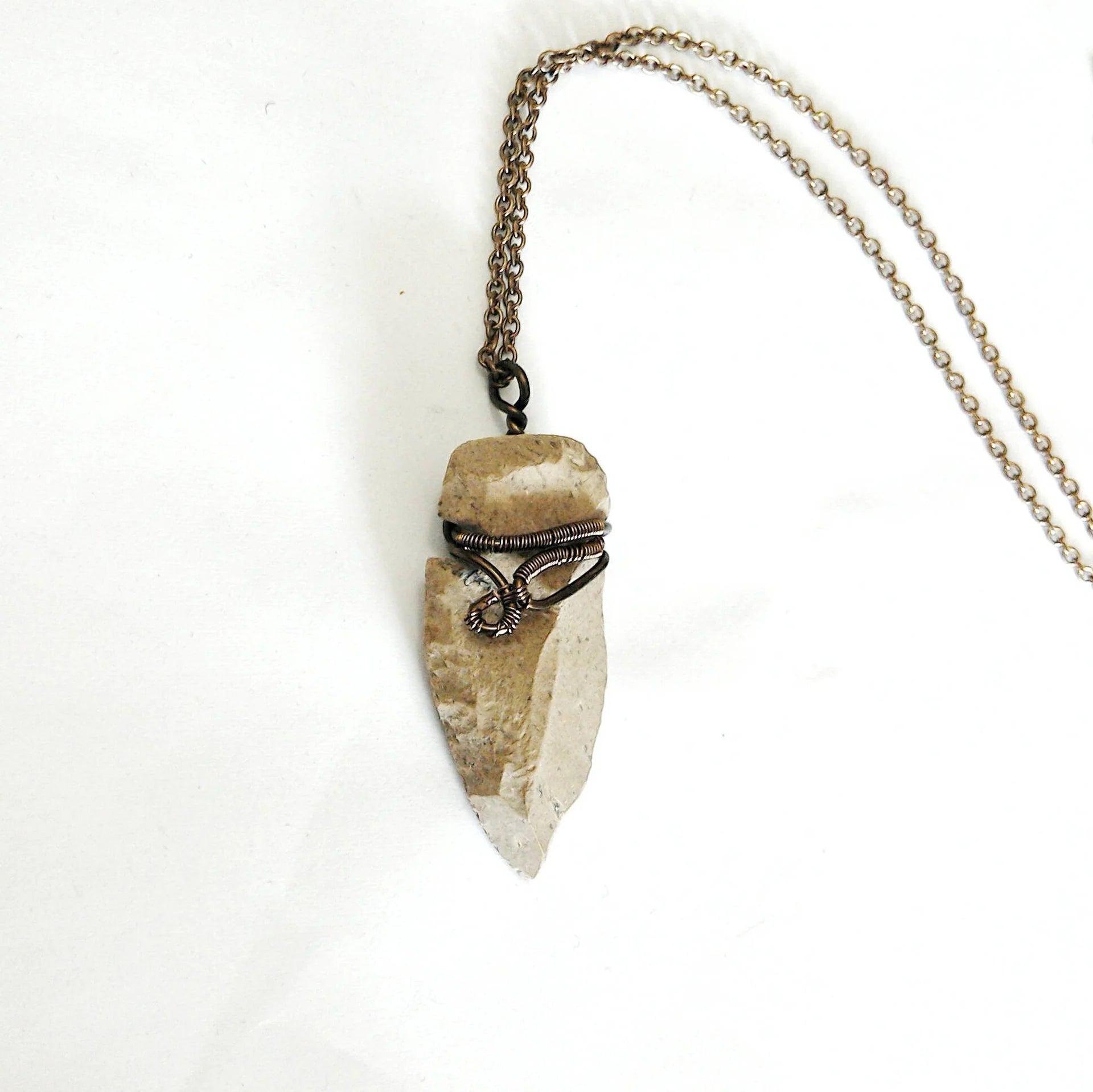 Flint arrowhead necklace for men on antique bronze chain – natural flint stone, detailed artisan wire wrapping, earthy masculine style.