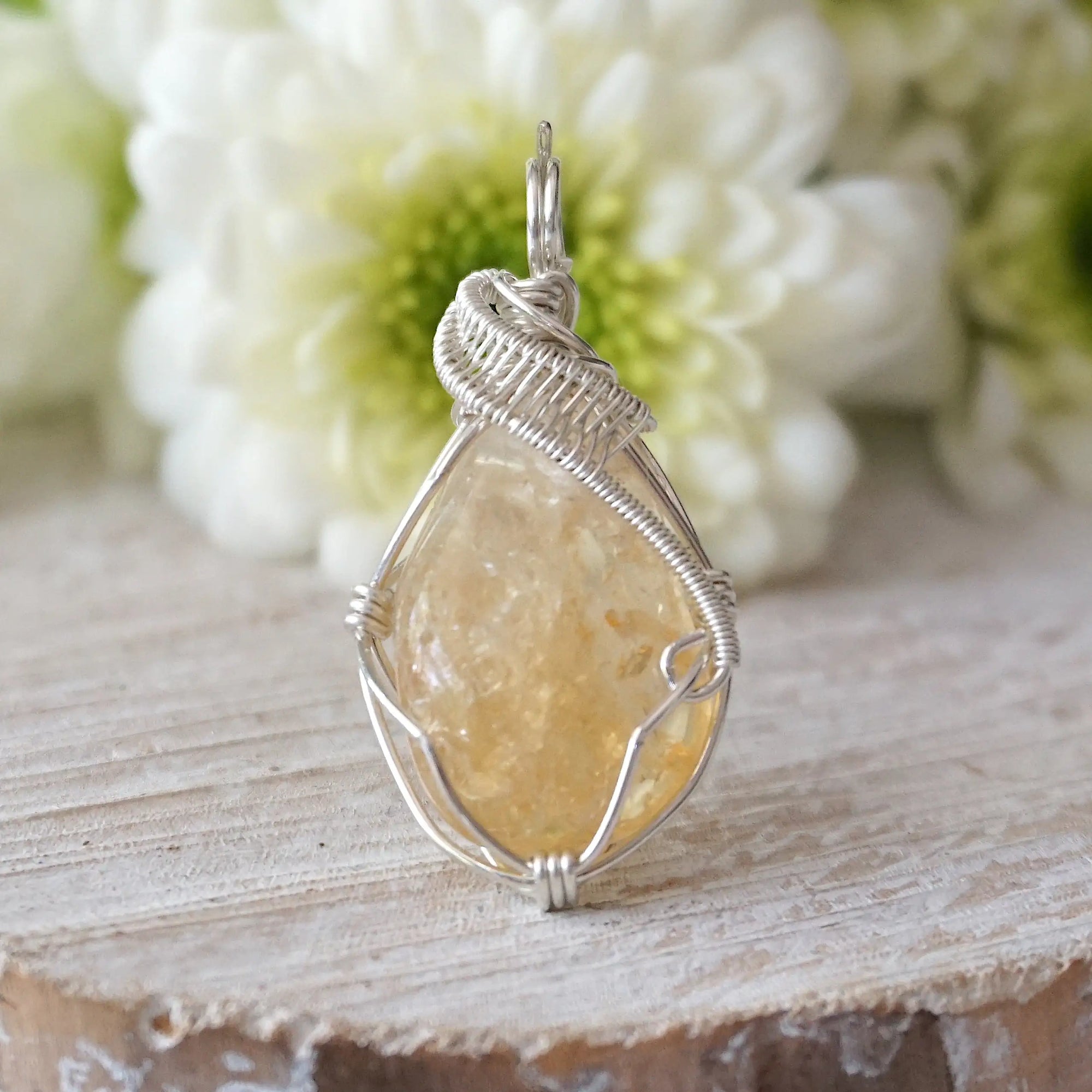 Front view of wire wrapped citrine pendant showing sterling silver wire wrapping detail and natural raw crystal
