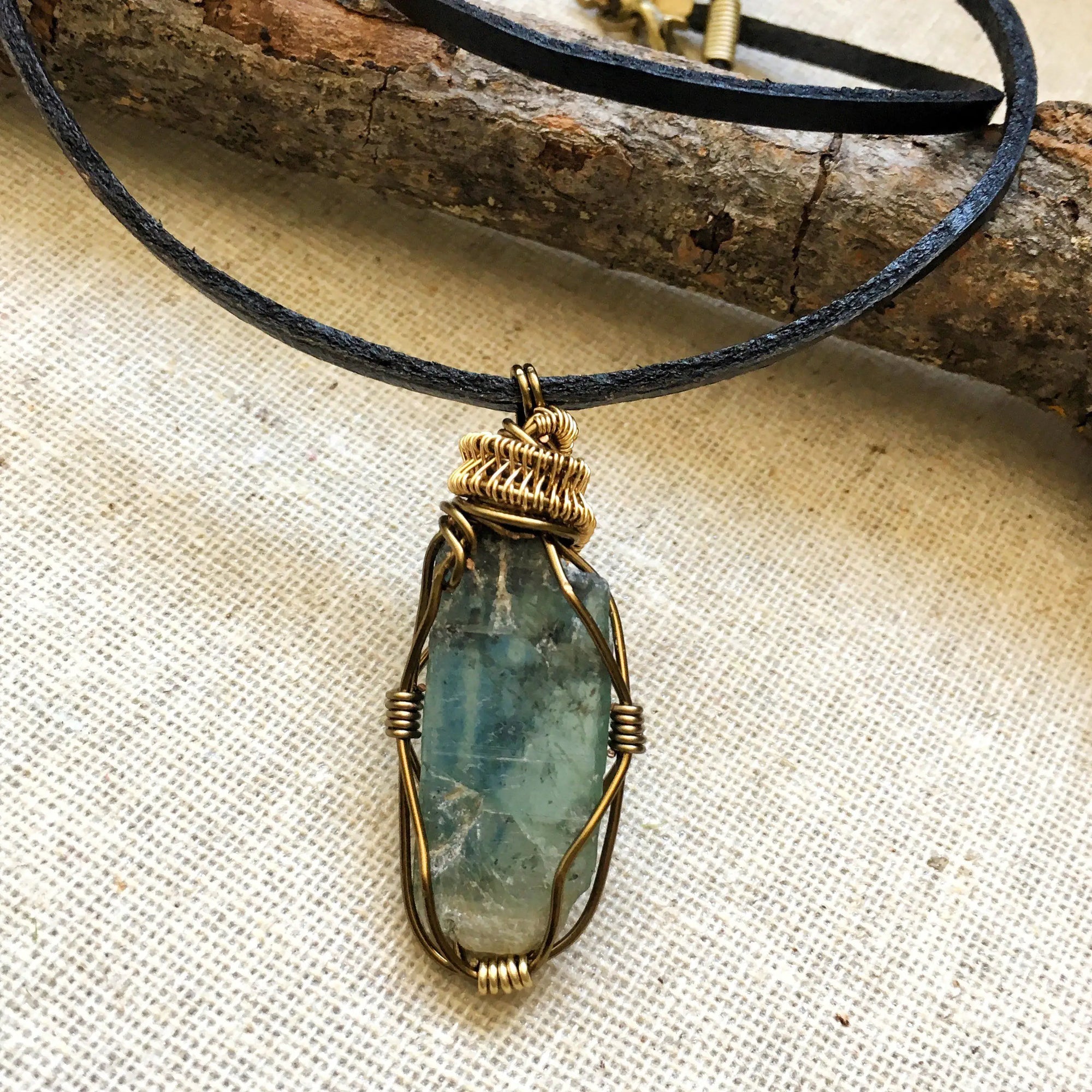 Handcrafted green kyanite necklace for men, front view – artisan antique bronze and gold copper wire wrapping, alternative May birthstone, natural crystal pendant.