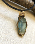 Right angle close-up of green kyanite necklace for men – detailed antique bronze and gold copper wire wrapping, natural raw green kyanite, masculine design.