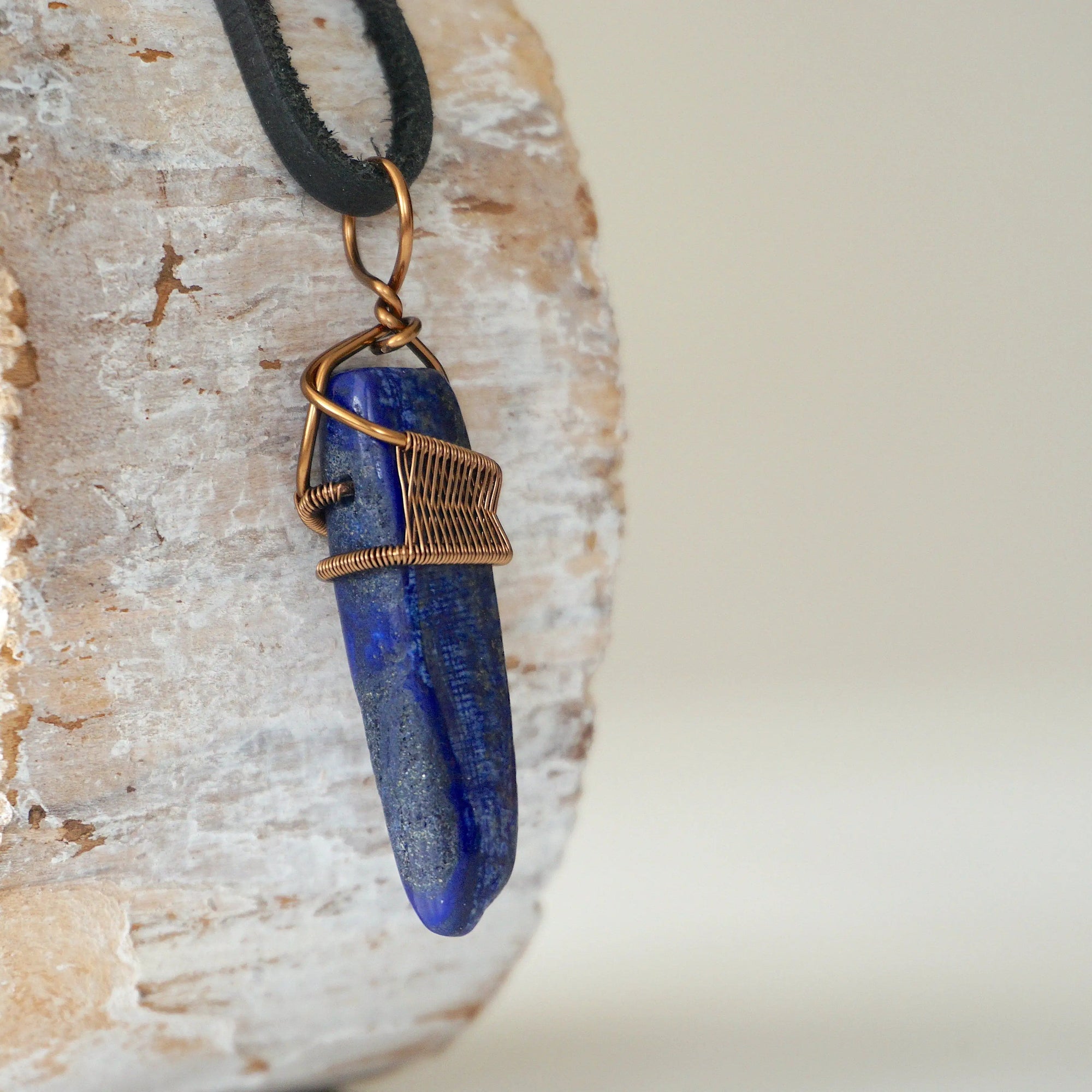 Right angle close-up of lapis lazuli point necklace for men – detailed antique bronze copper wire wrapping, natural lapis lazuli crystal.