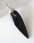 Back view of handcrafted Orthoceras fossil pendant for men – natural fossil pattern and wire wrapping, ancient ocean jewelry.