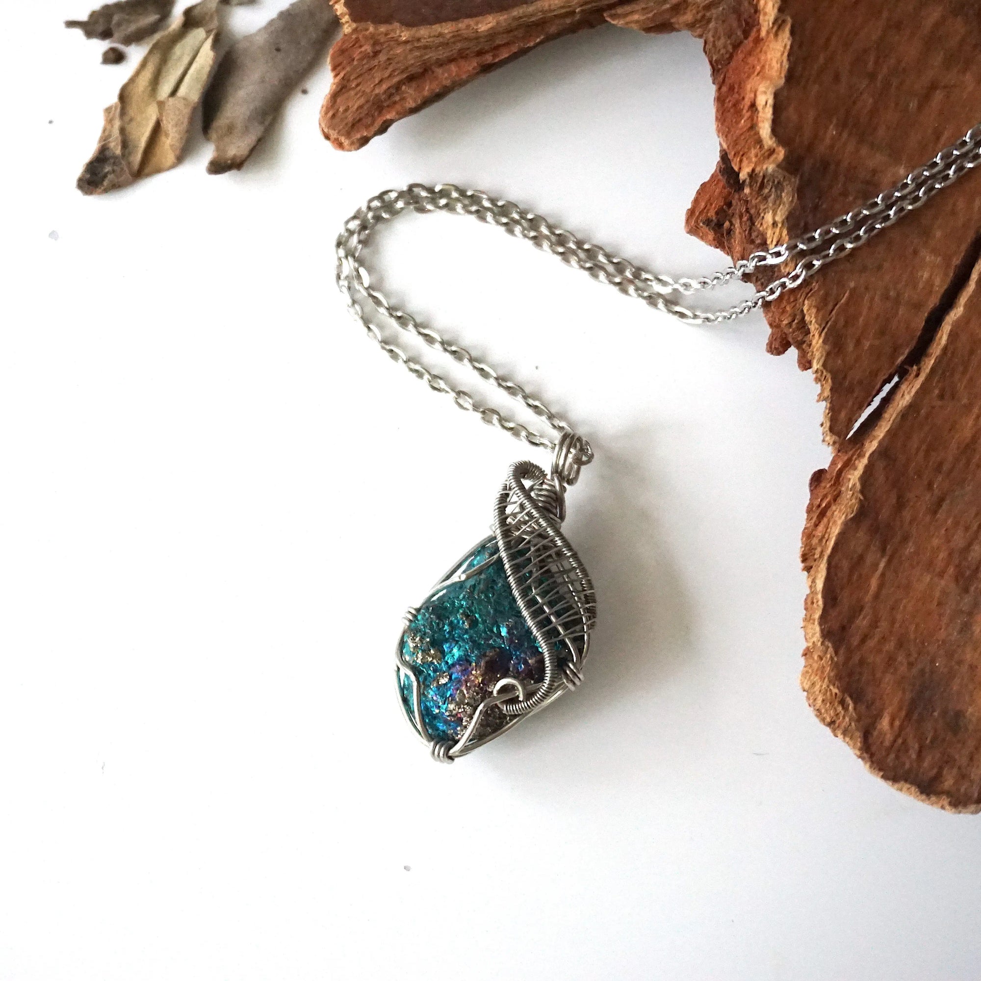 Handcrafted peacock ore necklace for men, laying flat on white gold chain – artisan wire wrapped, Capricorn and Cancer birthstone, natural crystal pendant.