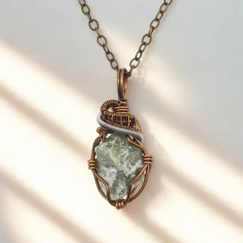 Necklace with a green stone pendant on a white background