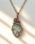 Necklace with a green stone pendant on a white background