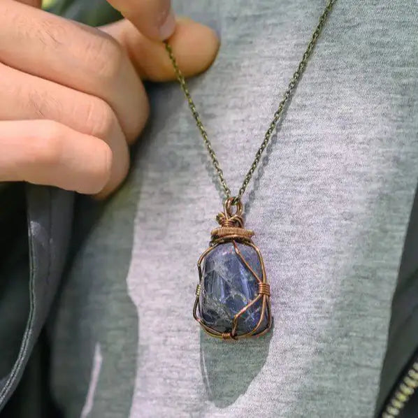 Sapphire necklace worn by male model – genuine raw sapphire pendant, bronze copper wire, unisex September birthstone jewelry.