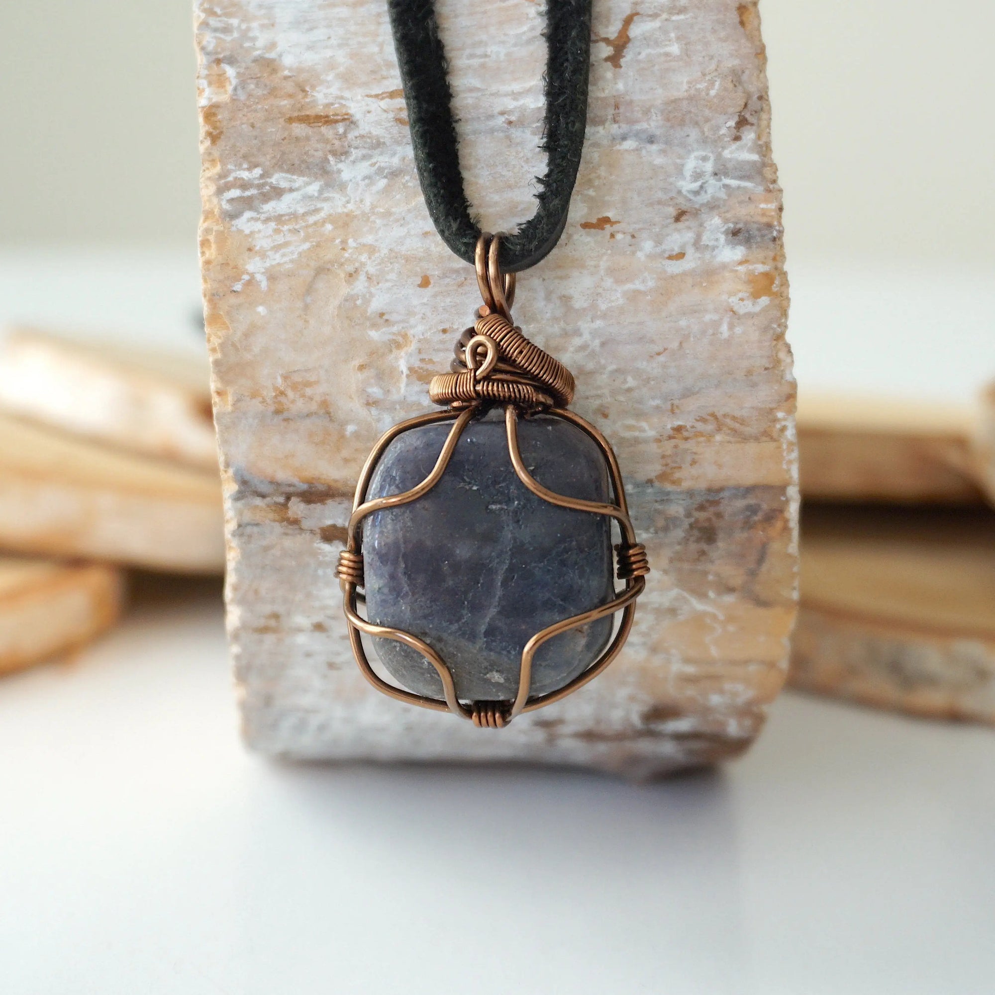 Back view of handcrafted men's sapphire necklace – natural stone and wire wrapping, September birthstone, black leather cord.