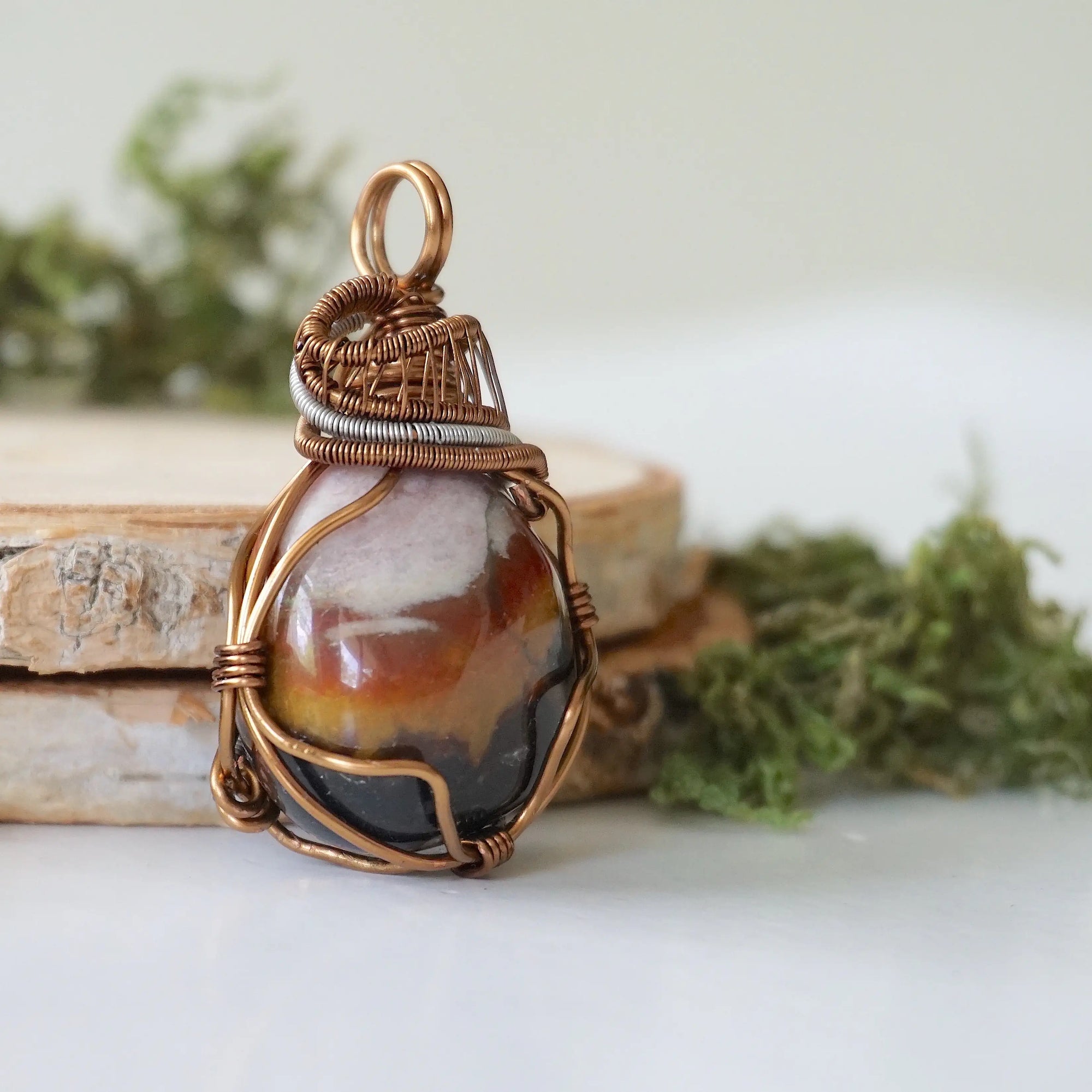 Right angle close-up of sardonyx necklace – highlighting unique wire-wrapped artistry, raw sardonyx crystal, gender-inclusive jewelry.