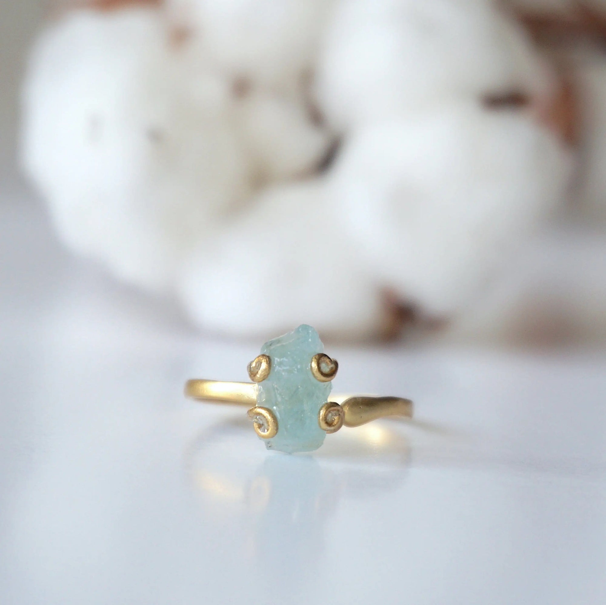 Detailed front angle of adjustable aquamarine ring, raw aquamarine, 14k gold vermeil prong setting