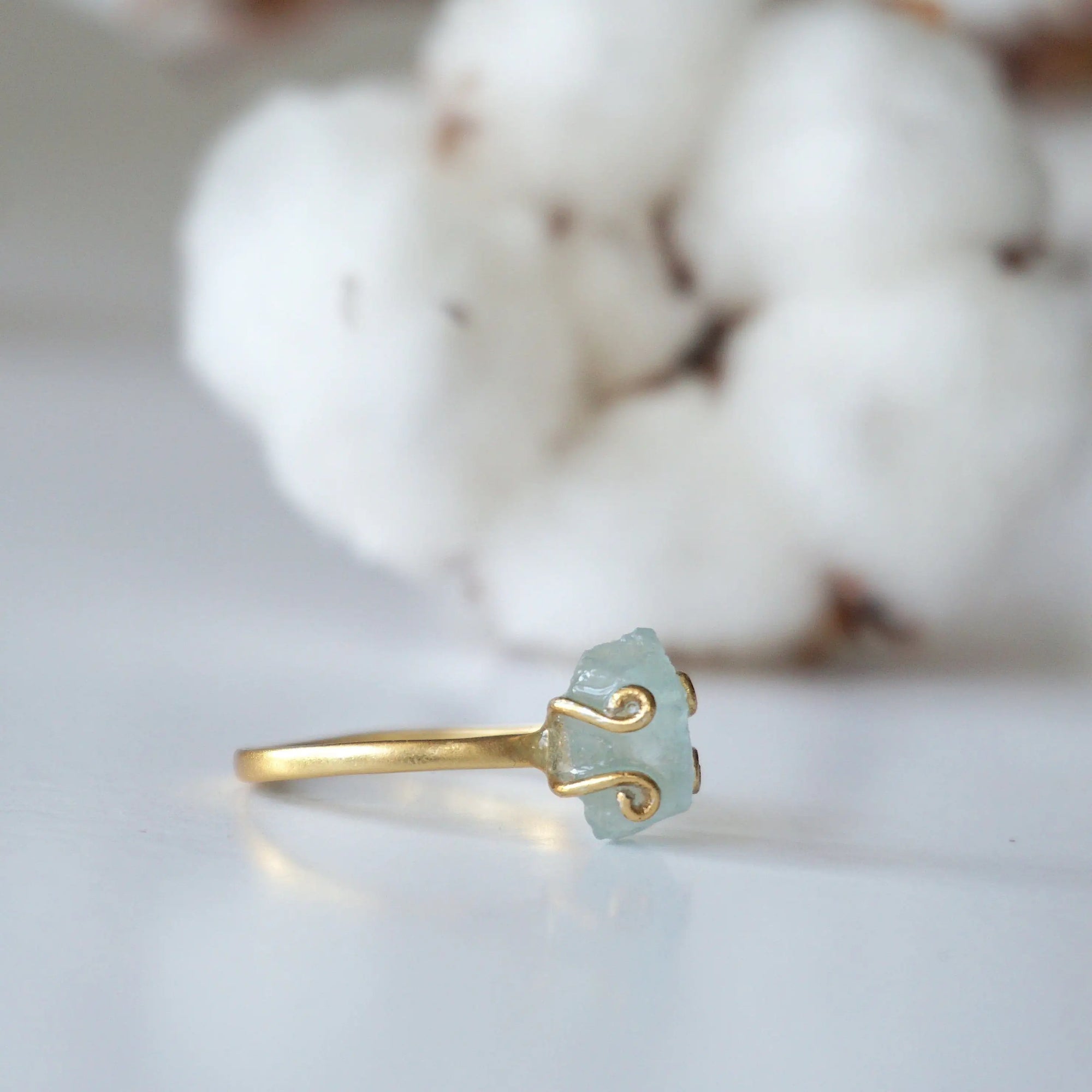 Right angle view of adjustable aquamarine ring, highlighting prong setting and raw gemstone, 14k gold vermeil