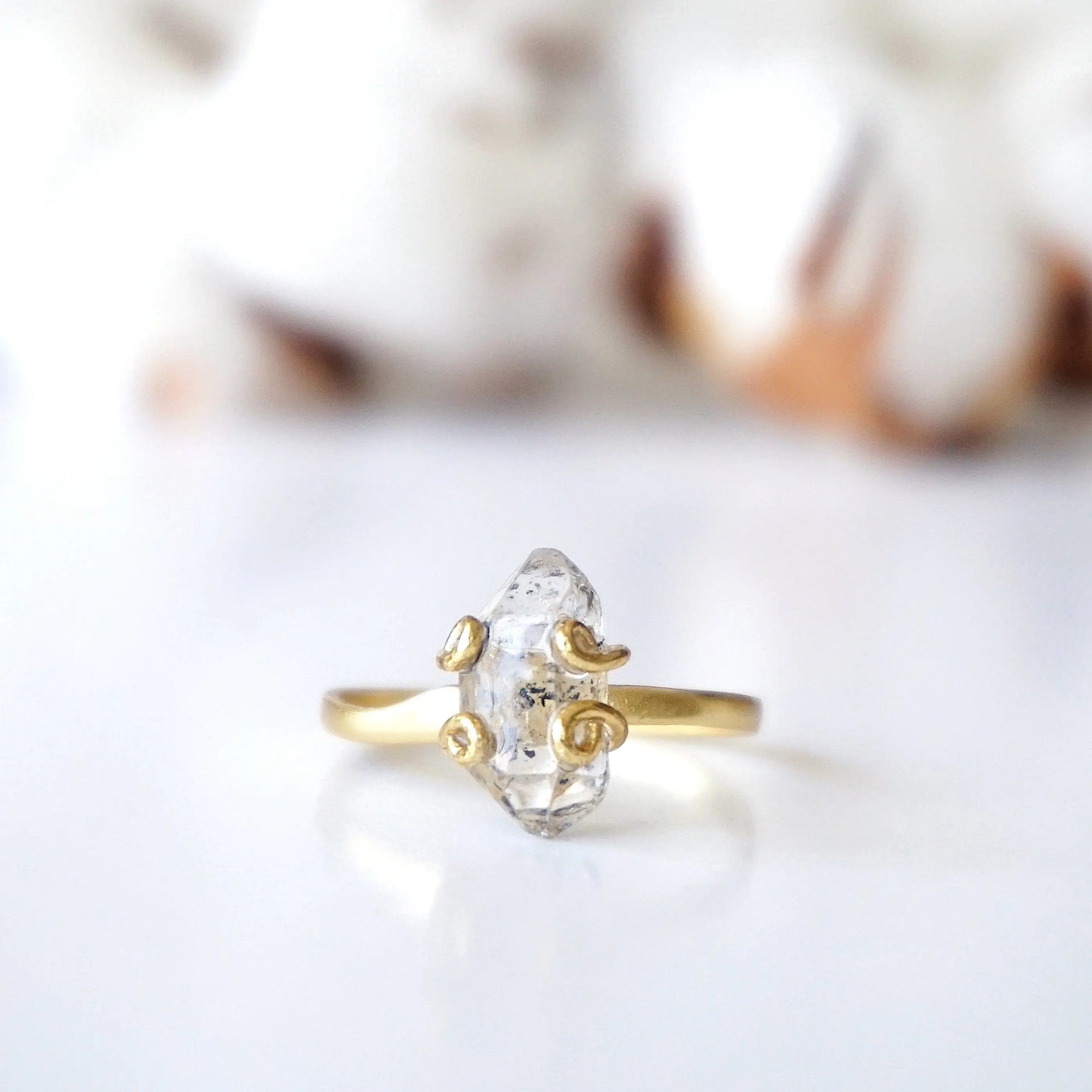 Detailed front view of adjustable raw Herkimer diamond ring in 14k gold vermeil focused on the natural stone.