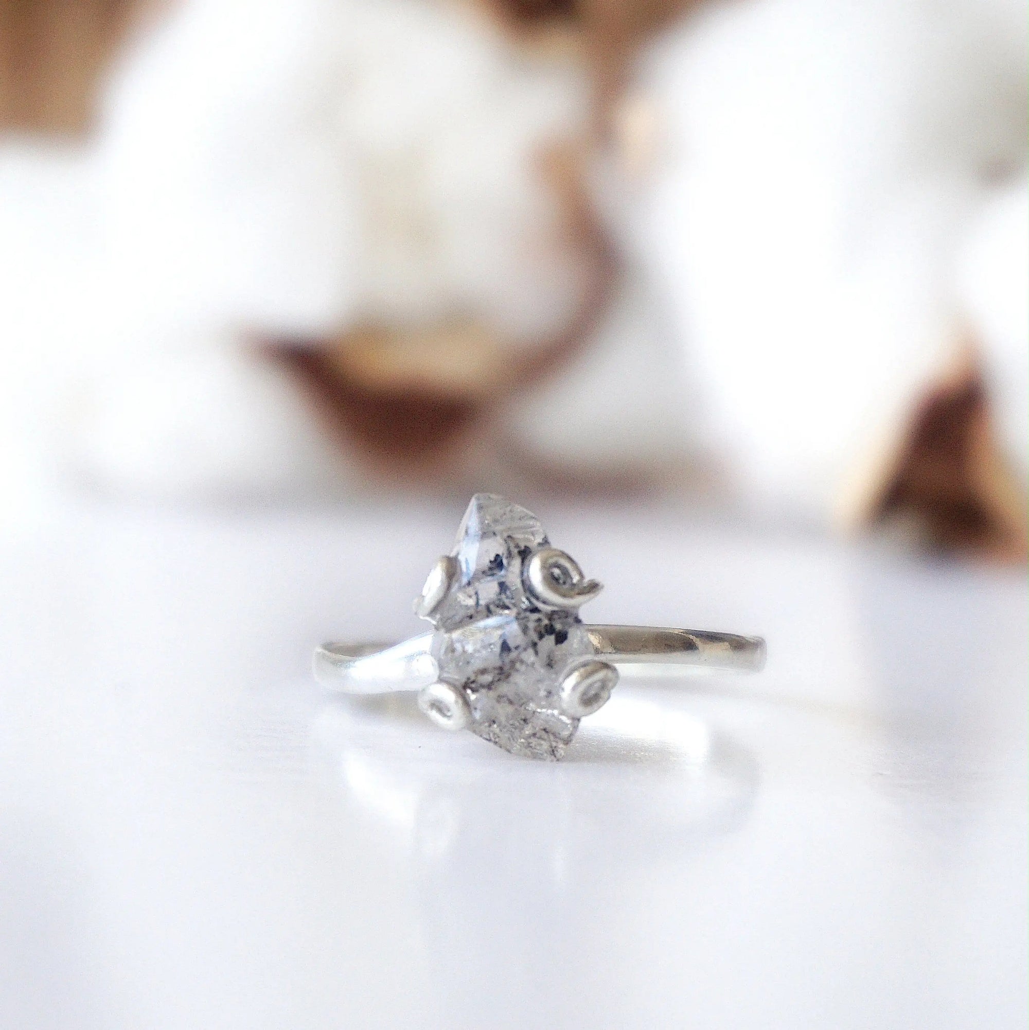 Detailed front view of adjustable raw Herkimer diamond ring in 925 sterling silver focused on the natural stone.