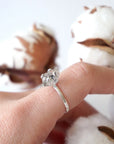Adjustable raw Herkimer diamond ring in sterling silver styled on a female model’s hand for everyday wear.