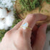 Adjustable raw rainbow moonstone ring on hand in 14k gold vermeil setting, natural moonstone flash, June birthstone ring for women.