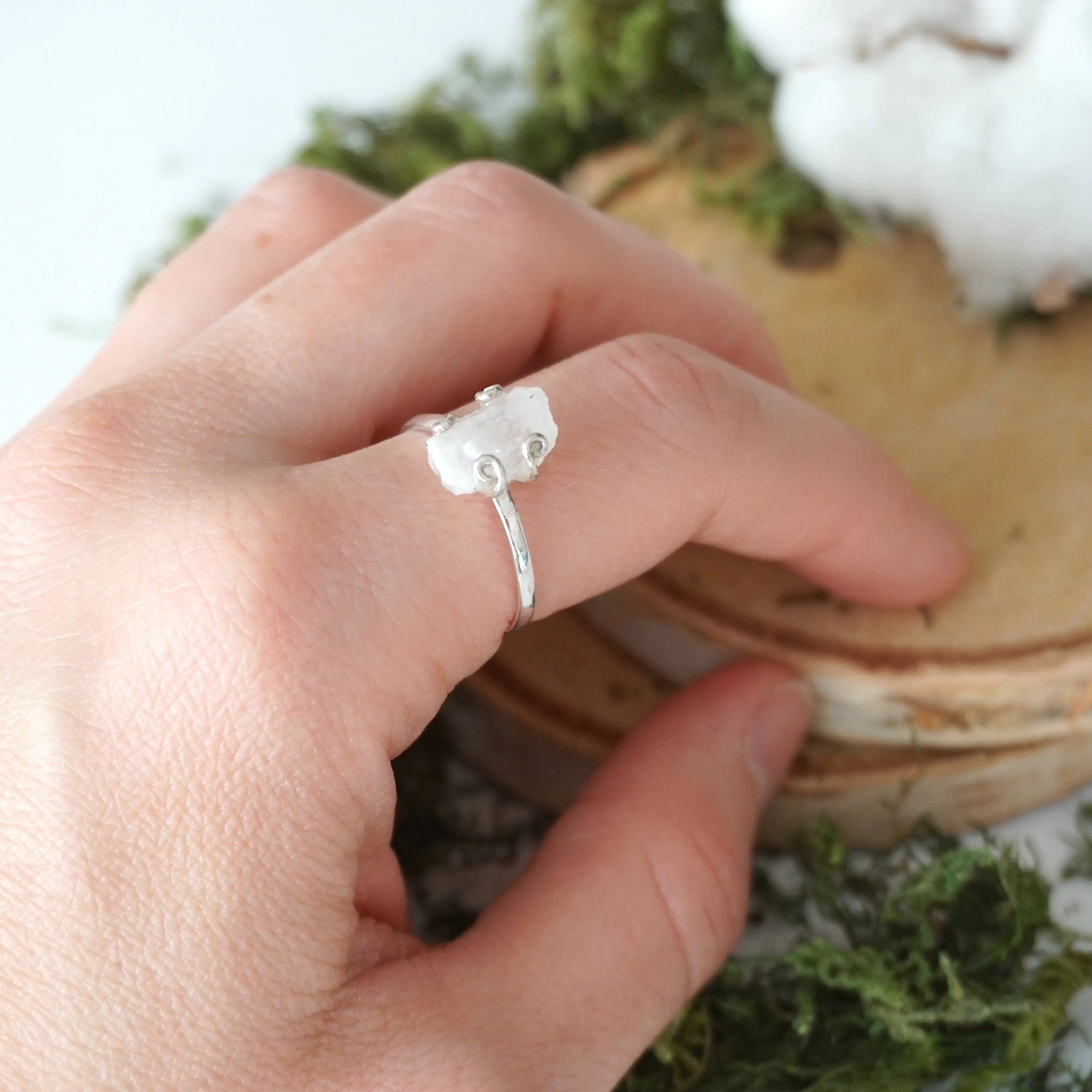 Adjustable raw rainbow moonstone ring on hand in 925 sterling silver setting, natural moonstone flash, June birthstone ring for women.