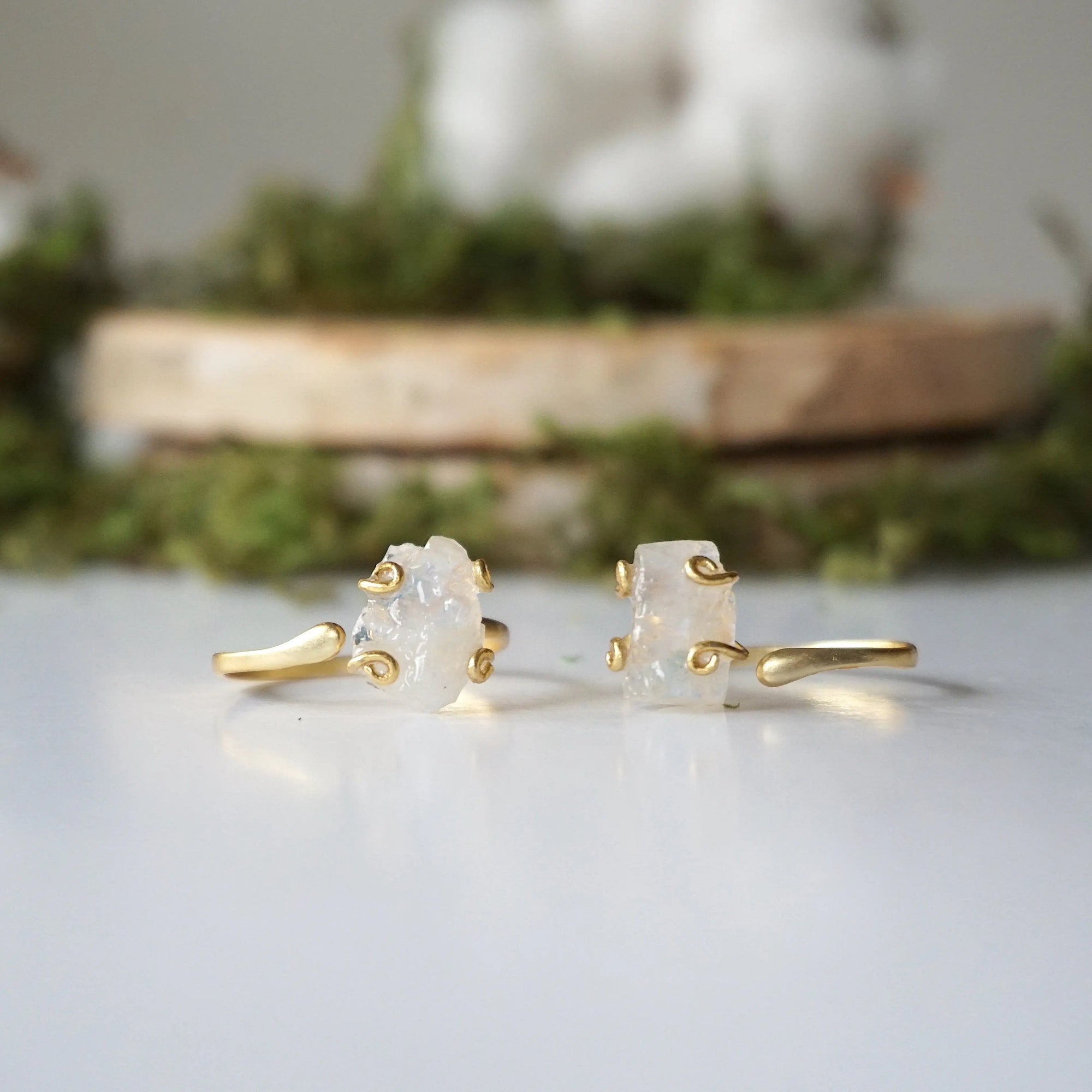 Two adjustable raw rainbow moonstone rings showing natural variation in stone size, shape, and moonstone flash in gold vermeil settings.