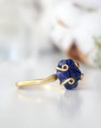 Right-side angle of adjustable raw sapphire ring showing the gold vermeil setting and natural stone profile