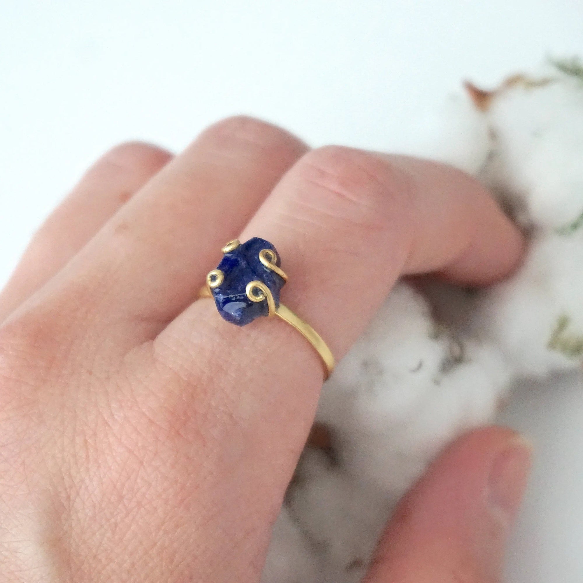 Woman wearing an adjustable raw sapphire ring in gold vermeil — September birthstone jewelry handcrafted by Designs by Nature Gems