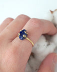 Woman wearing an adjustable raw sapphire ring in gold vermeil — September birthstone jewelry handcrafted by Designs by Nature Gems