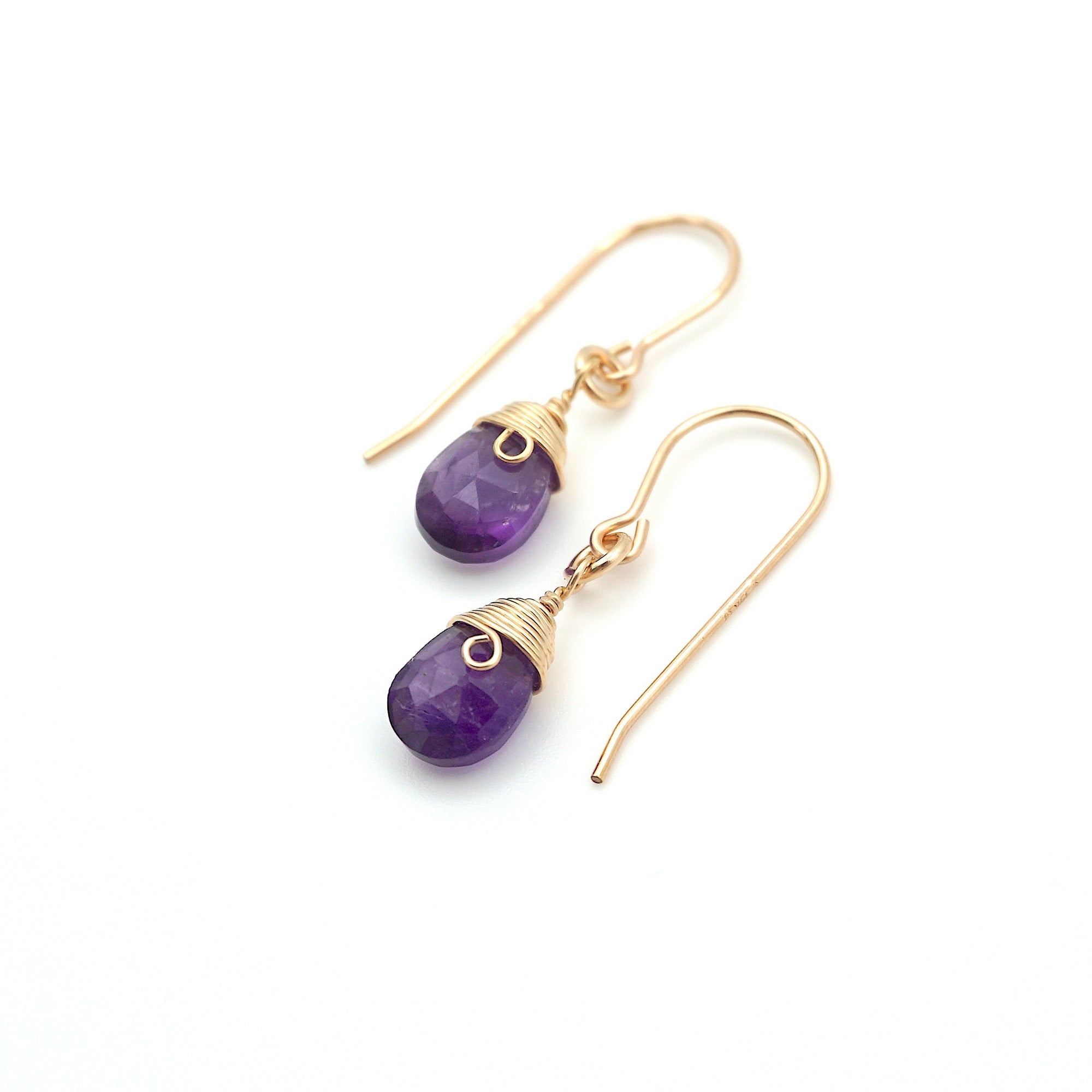 Angled look at amethyst drop earrings, artisan wire wrapping in 14k gold filled, February birthstone