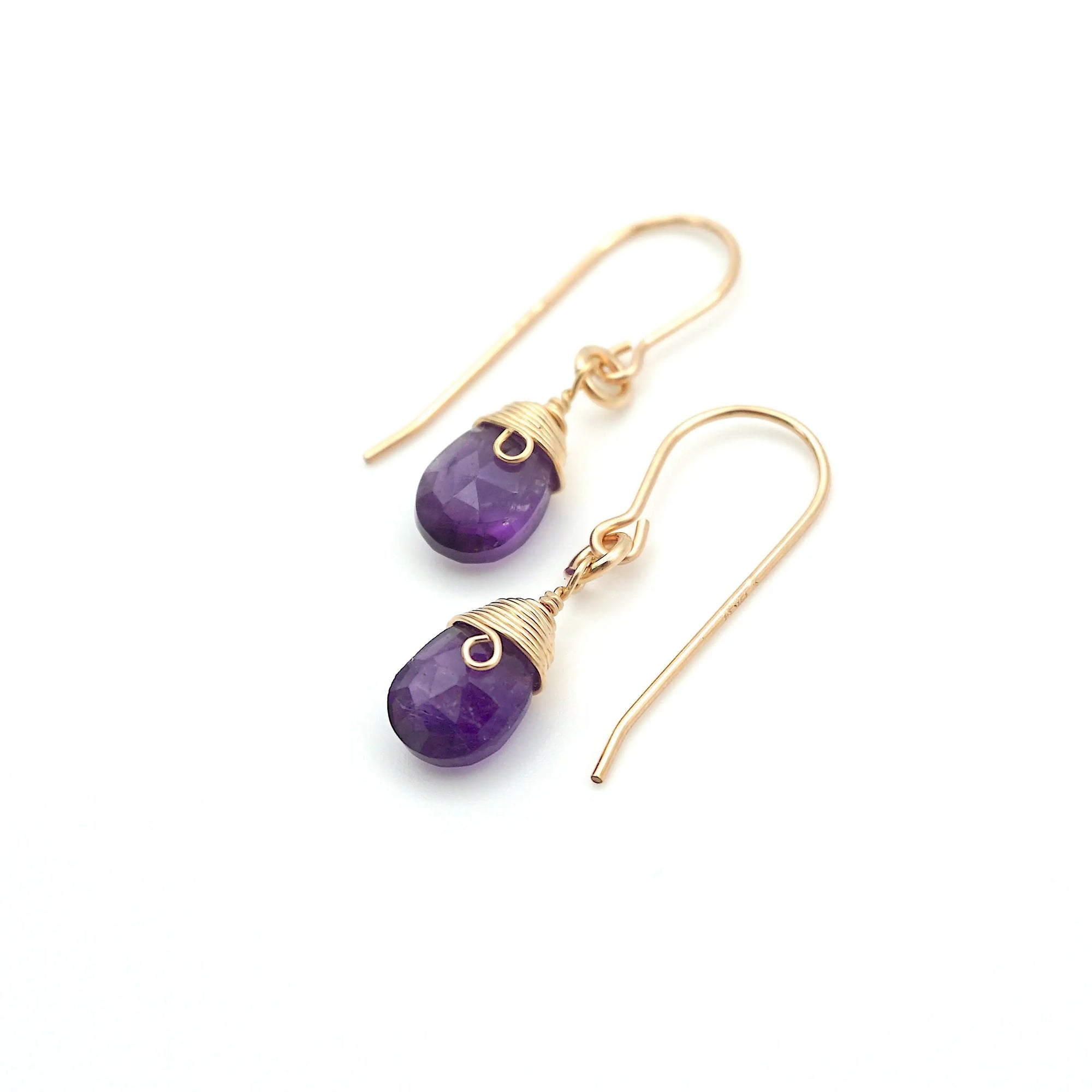 Angled look at amethyst drop earrings, artisan wire wrapping in 14k gold filled, February birthstone