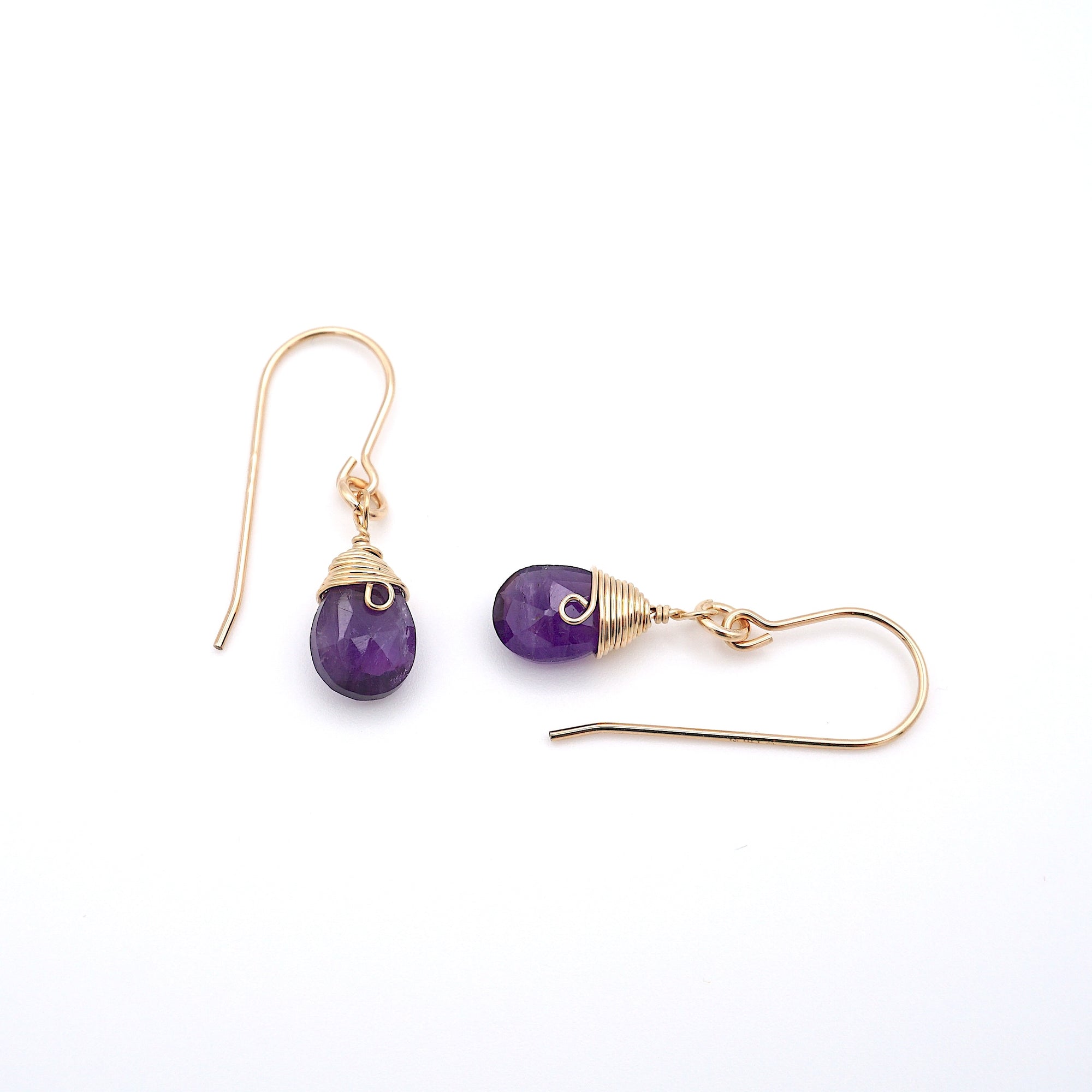 Closeup showing details of amethyst drop earrings, faceted amethyst stone, 14k gold filled setting
