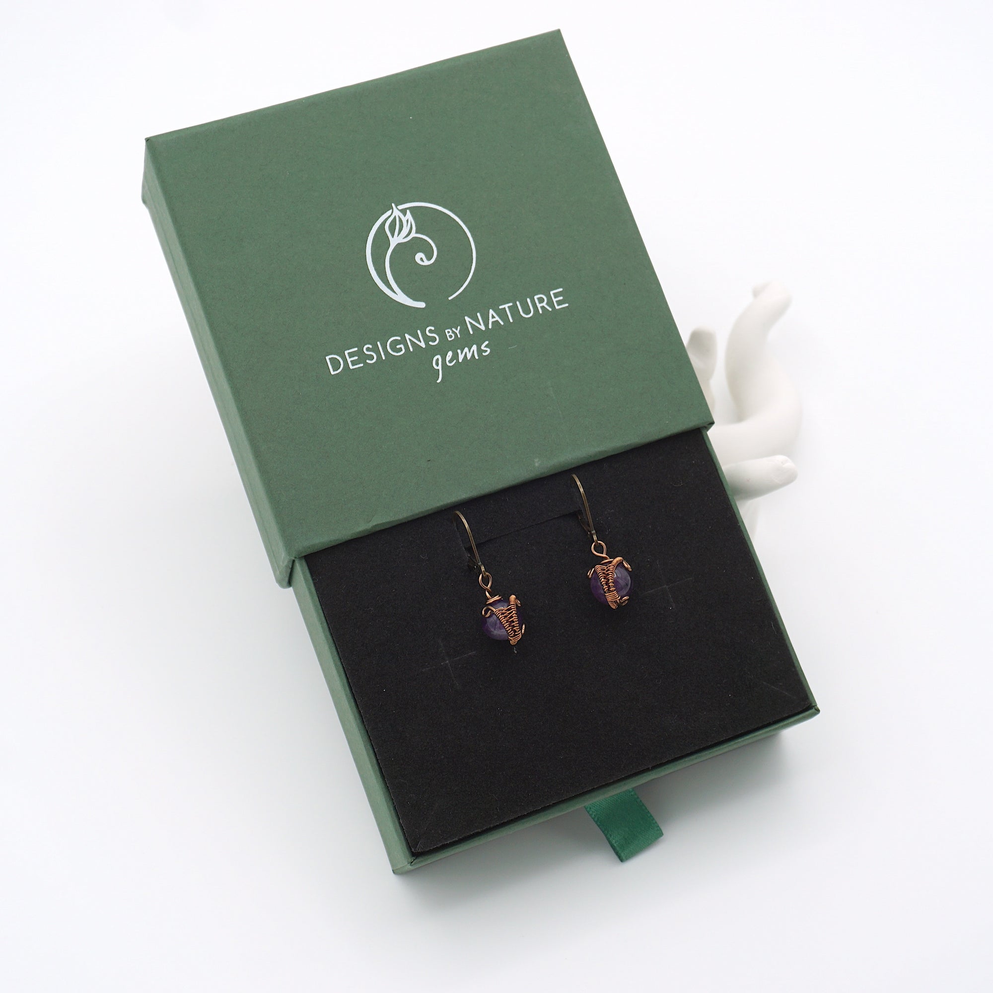 Amethyst drop earrings presented in a branded gift box, ready for gifting, with antique bronze copper wire wrapping.