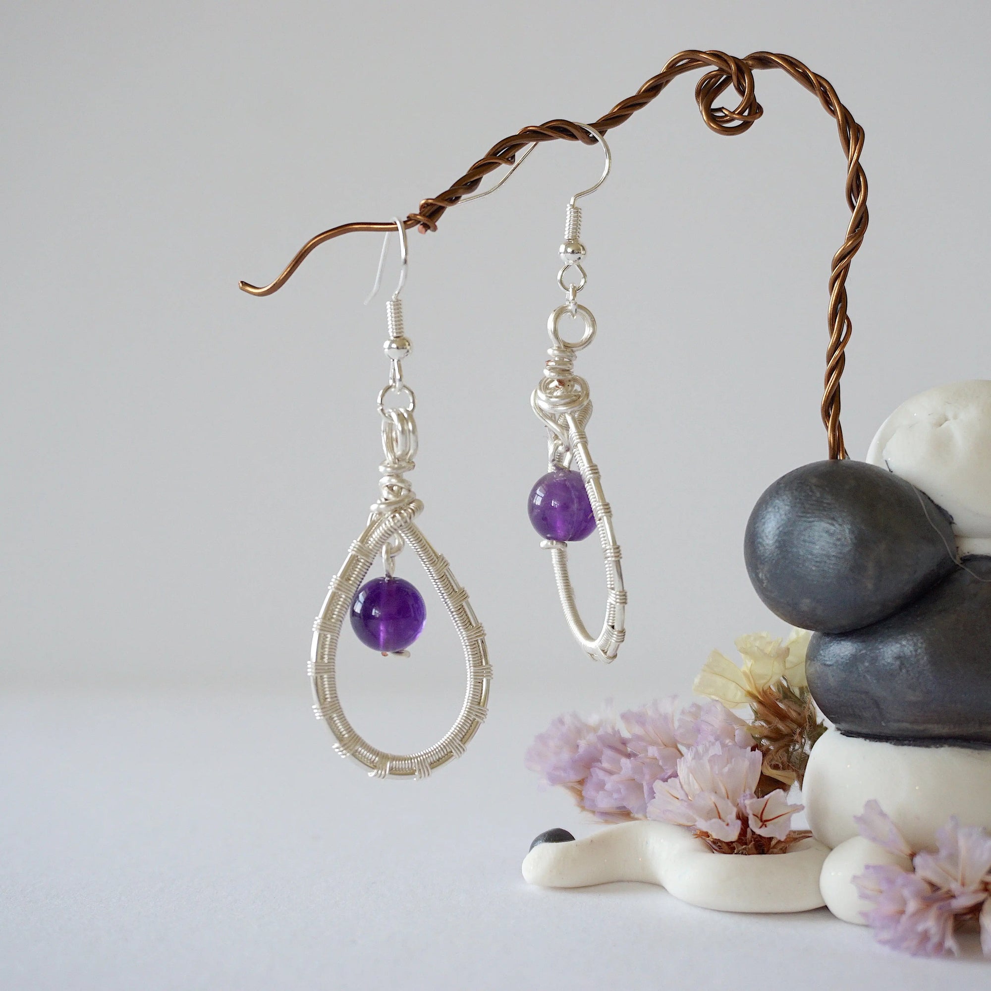 Front view of amethyst drop earrings with 8mm polished amethyst bead in silver plated copper wire wrapped teardrop dangle design