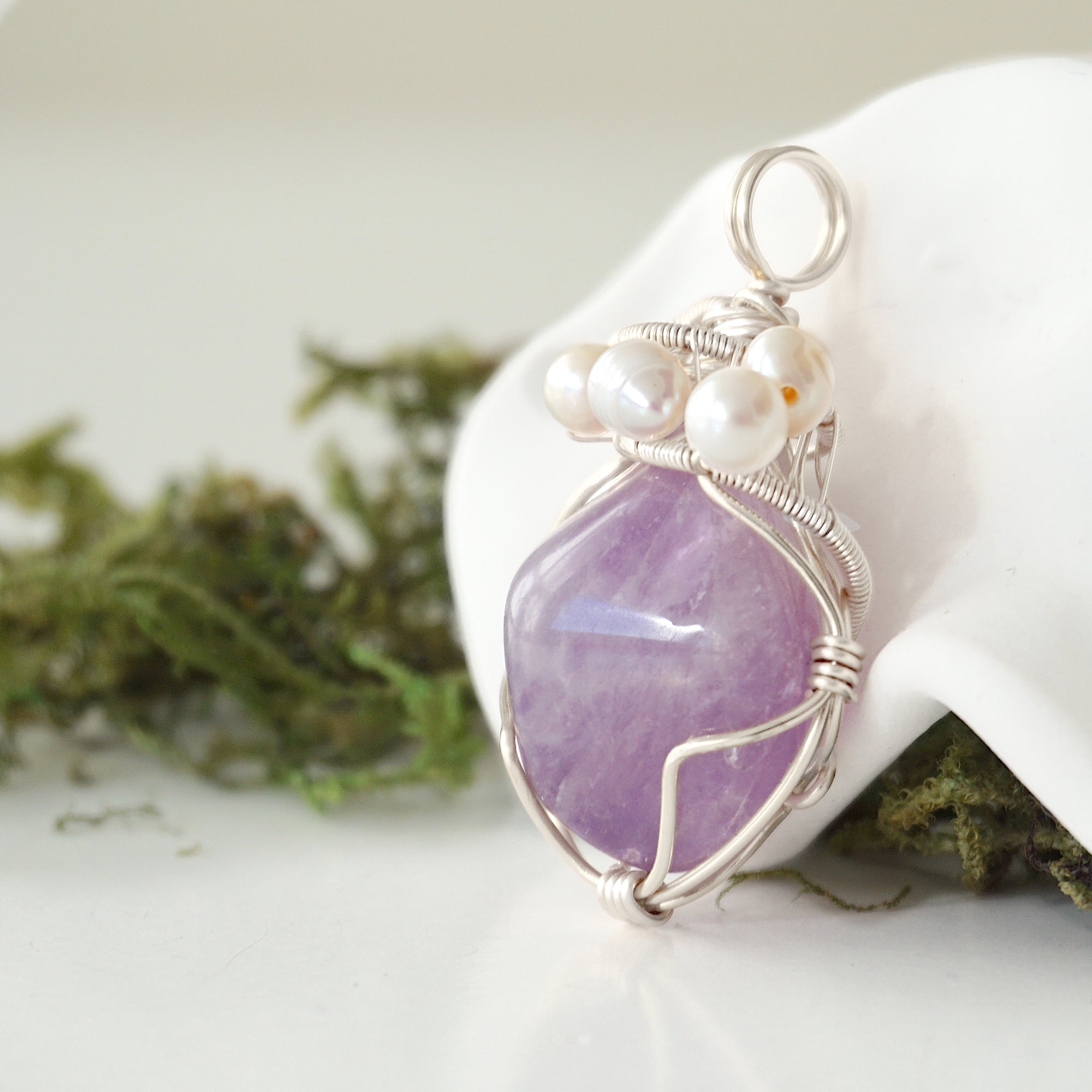 Side angle of handmade amethyst and freshwater pearl pendant necklace, silver wire wrapped jewelry