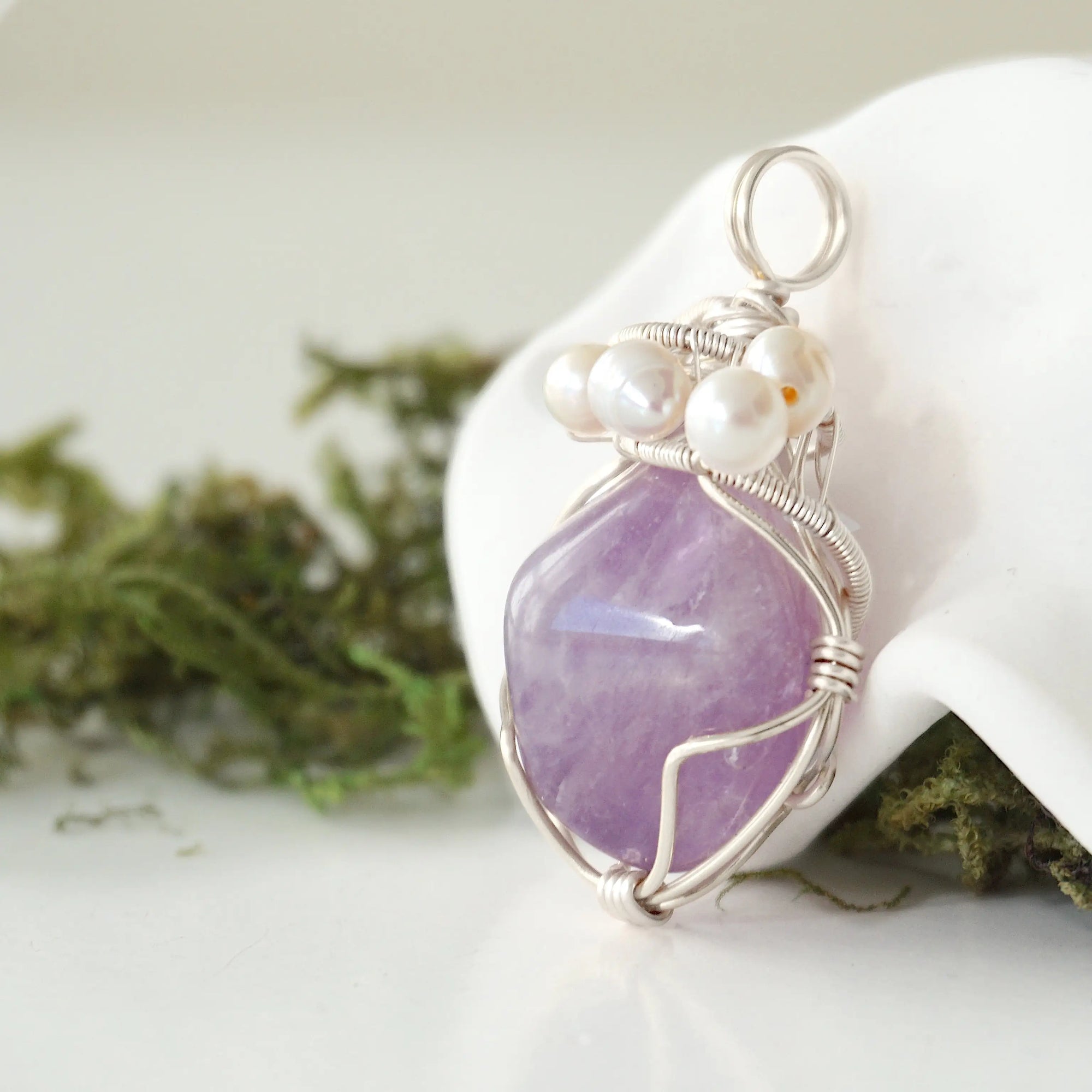 Side angle of handmade amethyst and freshwater pearl pendant necklace, silver wire wrapped jewelry