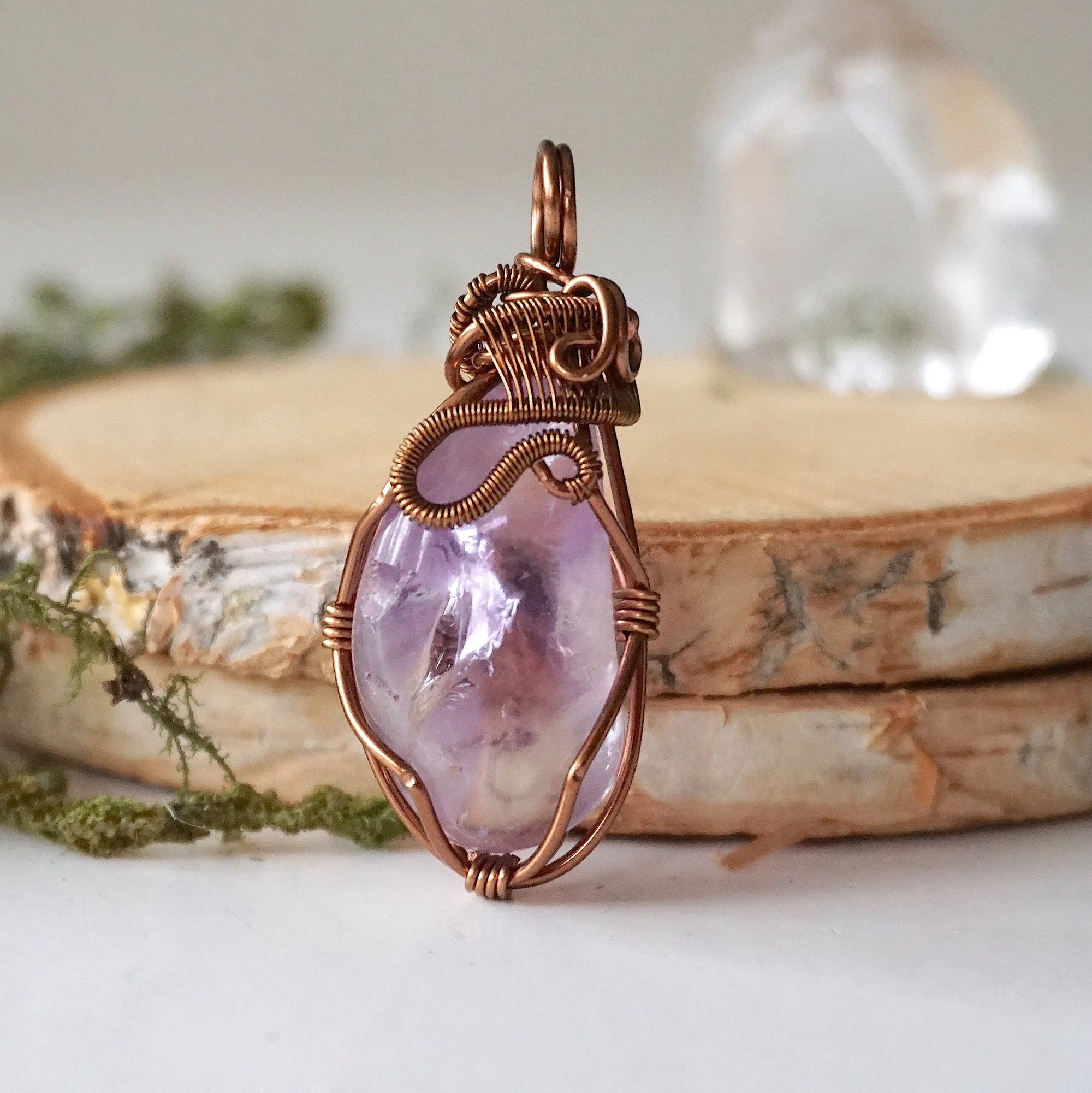 Back side angle of women’s amethyst pendant, lighter violet stone, antique bronze copper wire wrap
