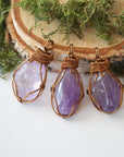 Three women’s amethyst necklaces showing natural variation in lighter violet amethyst stone size, shape, and color, antique bronze copper wire wrap