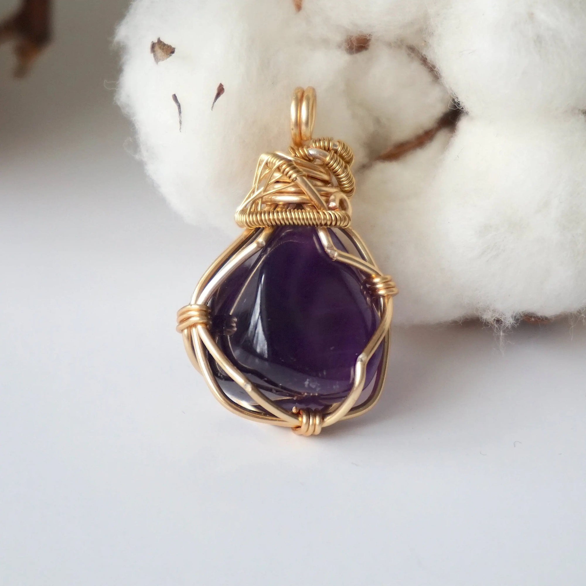Back side angle of women’s gold amethyst necklace, polished dark amethyst pendant, artisan gold plated copper wire wrap