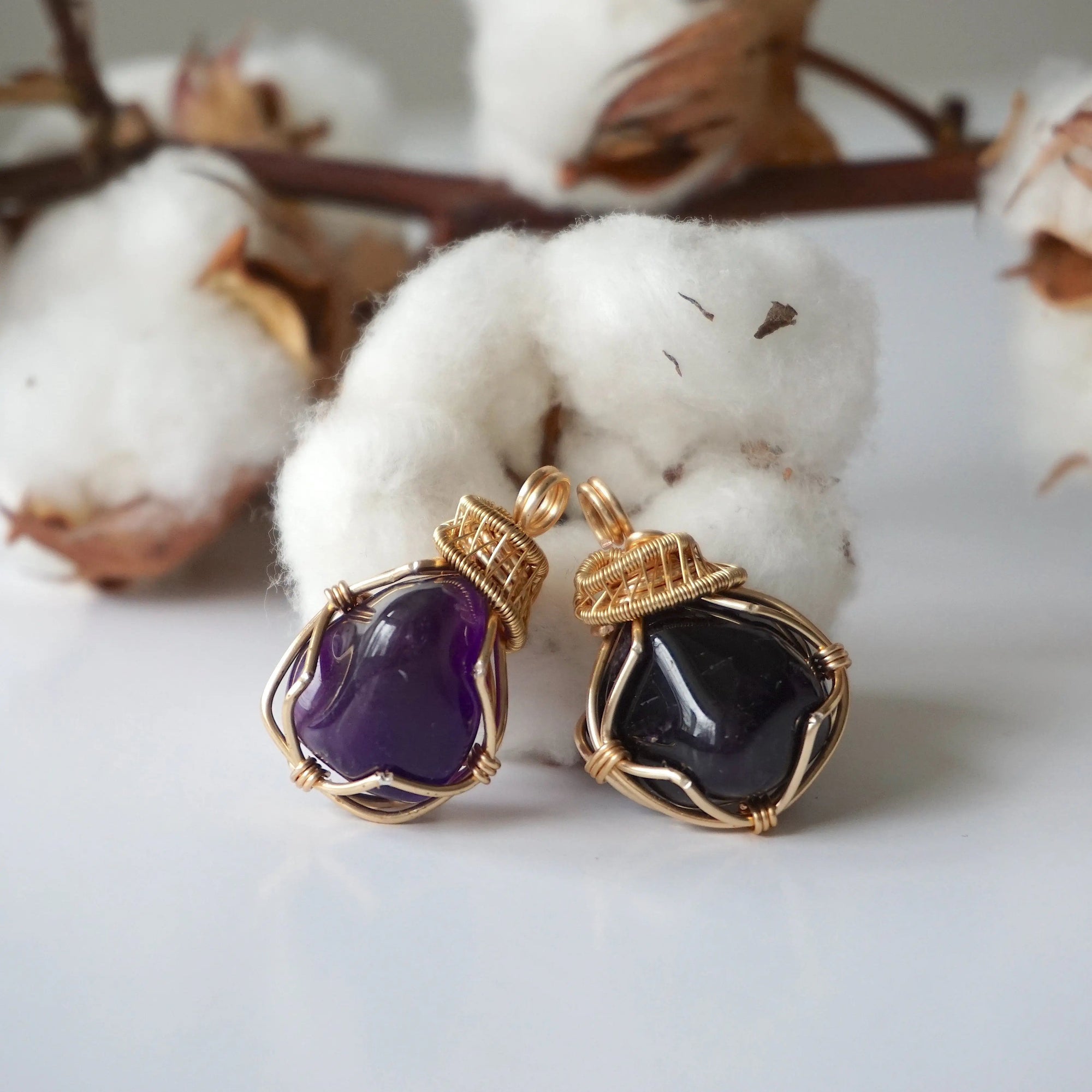 Two women’s gold amethyst necklaces showing natural variation in pendant size, shape, and color, artisan gold plated copper wire wrap