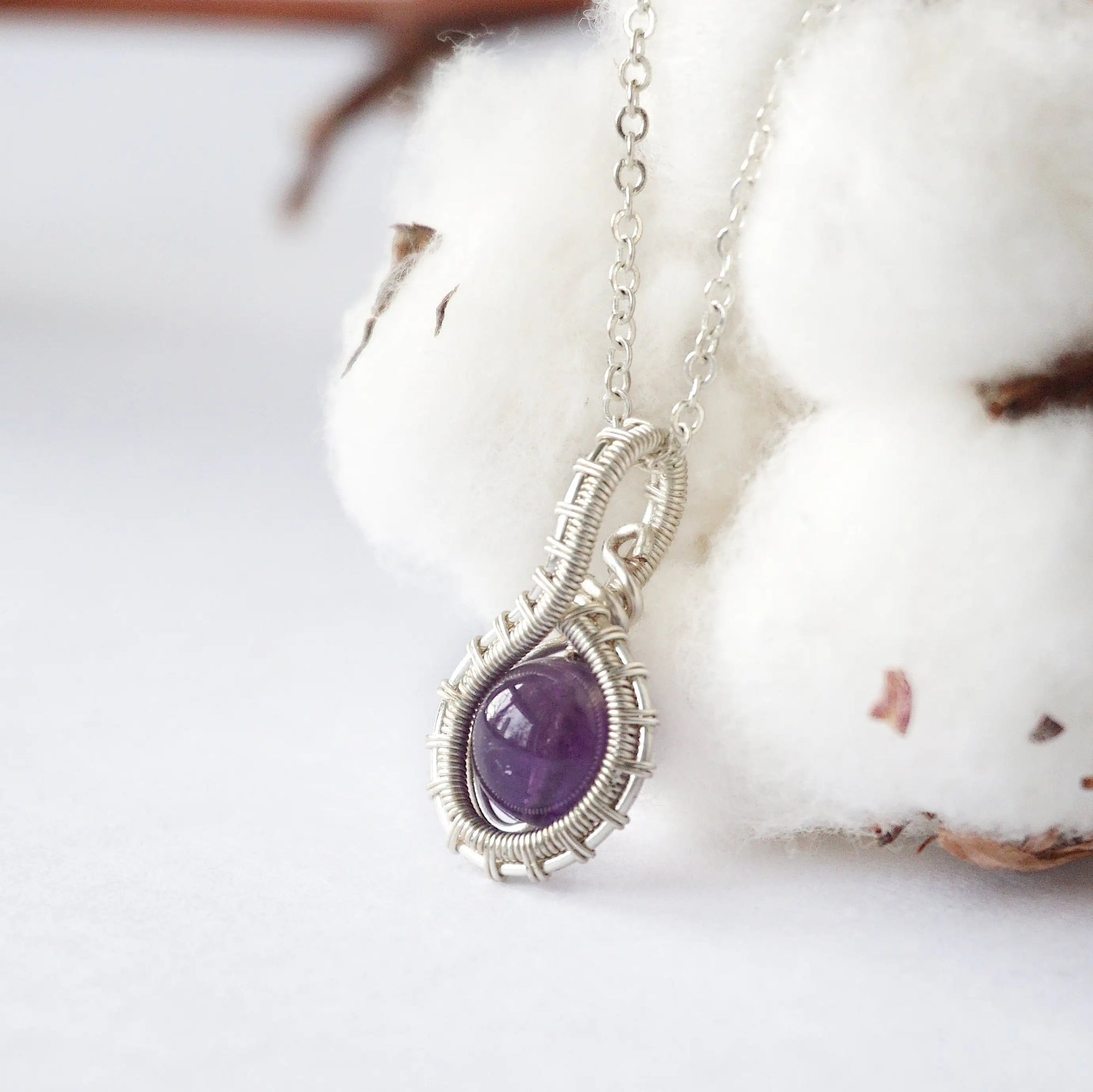 Left side angle of women’s amethyst necklace, 8mm amethyst bead, artisan silver plated copper wire wrap