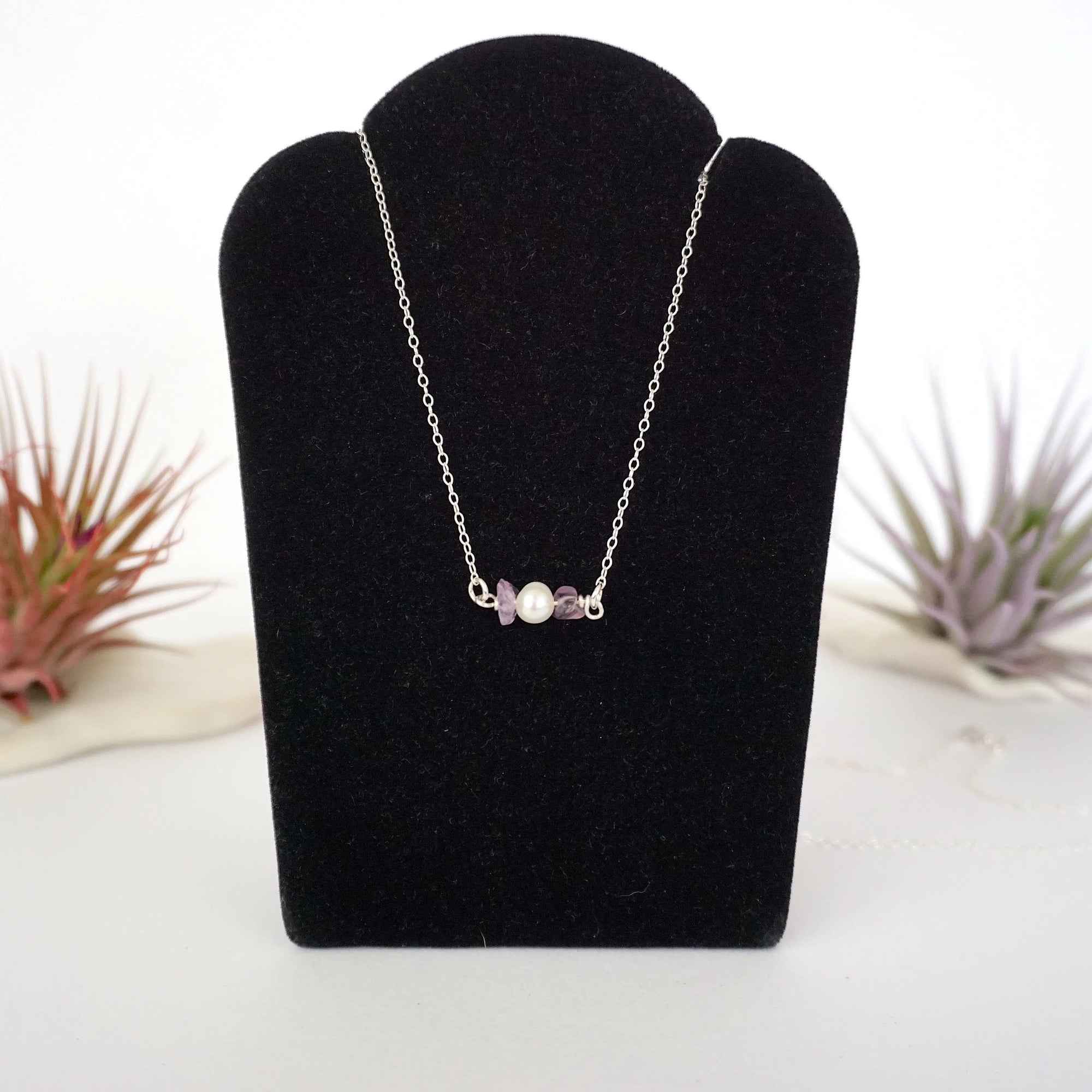 Amethyst and freshwater pearl bar necklace in 925 sterling silver on jewelry display, front view