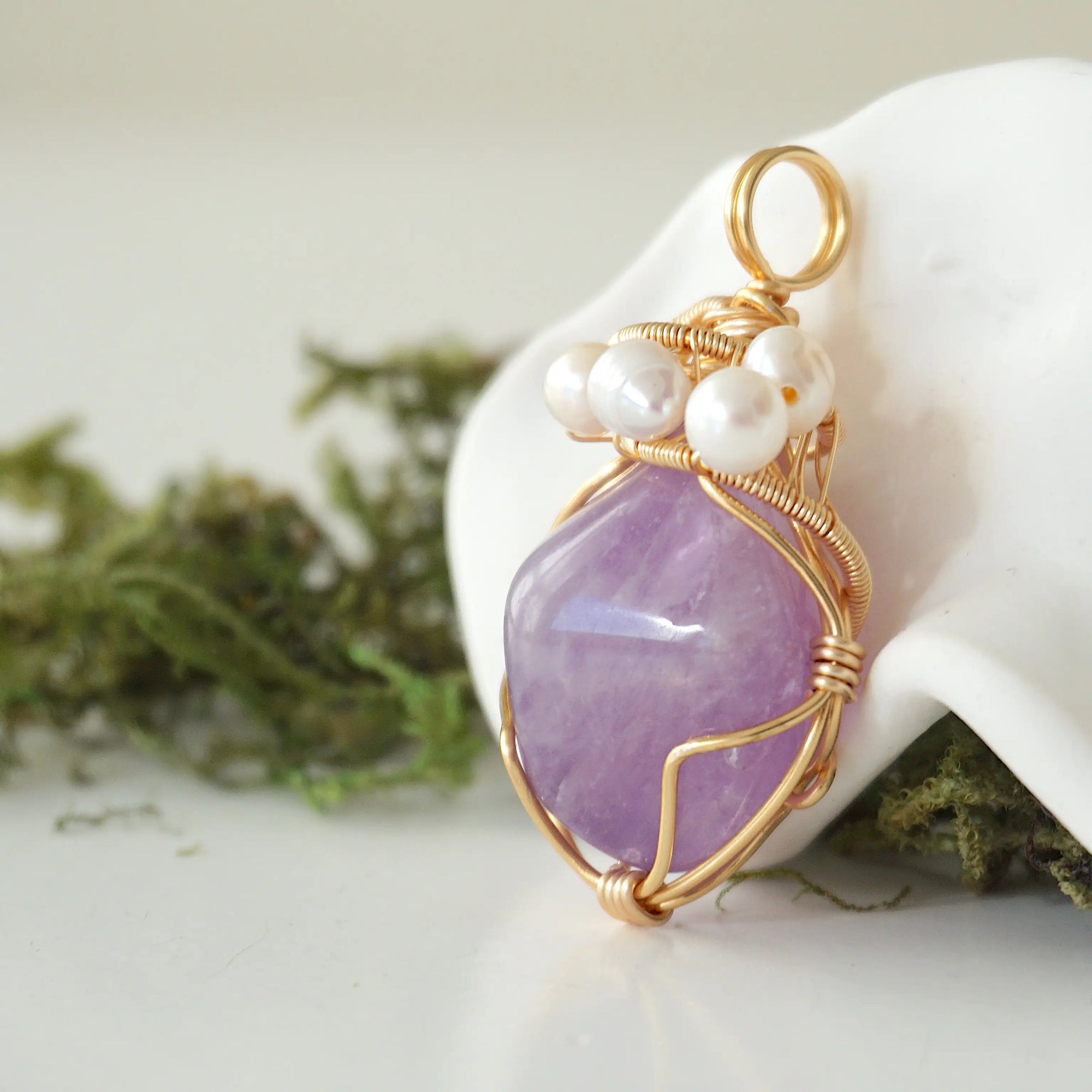 Side angle detail of amethyst and freshwater pearl pendant, gold wire wrapped, ethical artisan necklace