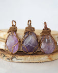 Multiple mens amethyst pendants showing natural variation in stone size, shape, and lavender colour — each one of a kind, February birthstone, bronze copper wire wrapped, Designs by Nature Gems