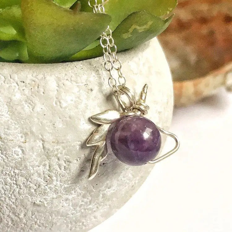 Detailed view of minimalist amethyst unicorn charm necklace, natural 8mm amethyst bead, sterling silver unicorn setting