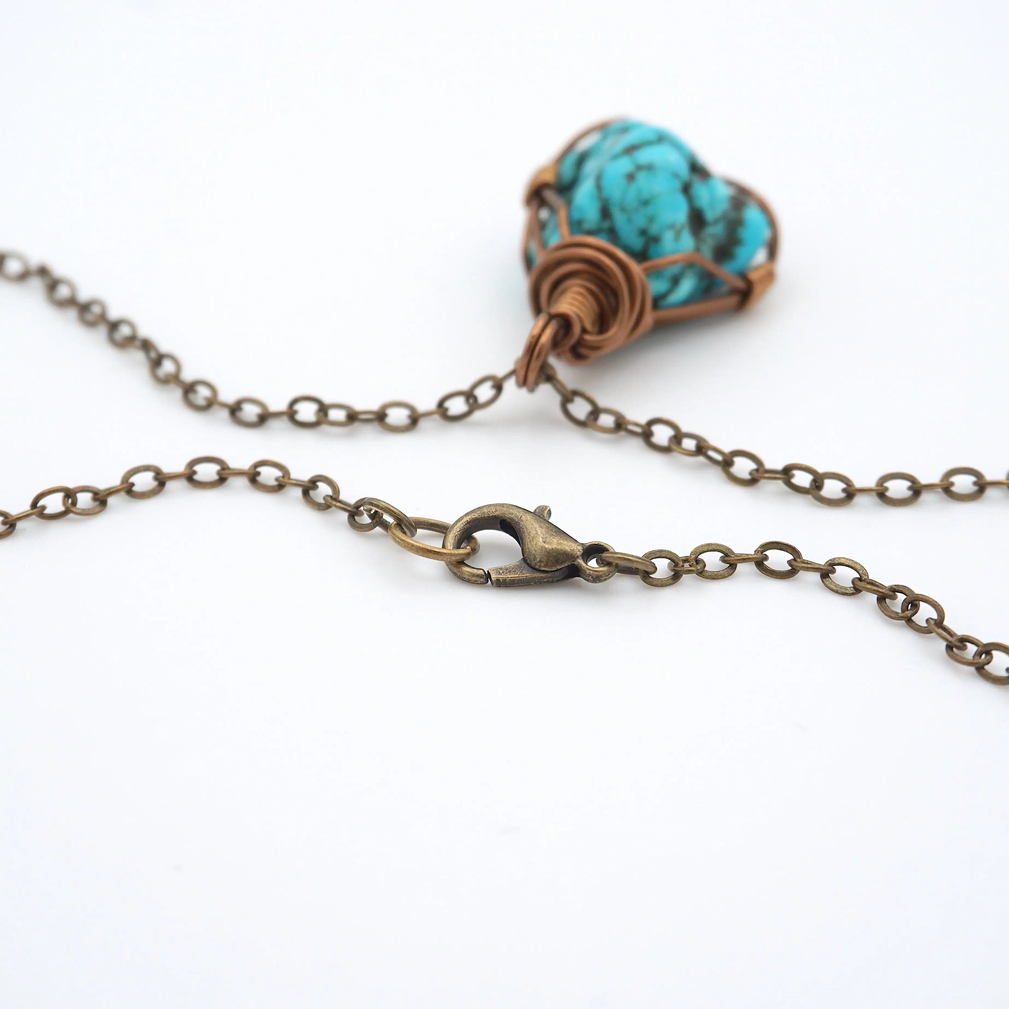 Close up of antique bronze chain clasp for raw turquoise necklace, quality hardware detail