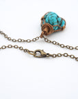 Close up of antique bronze chain clasp for raw turquoise necklace, quality hardware detail