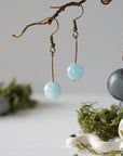 Minimalist aquamarine drop earrings on display, front view, genuine gemstone, antique bronze finish, Designs by Nature Gems