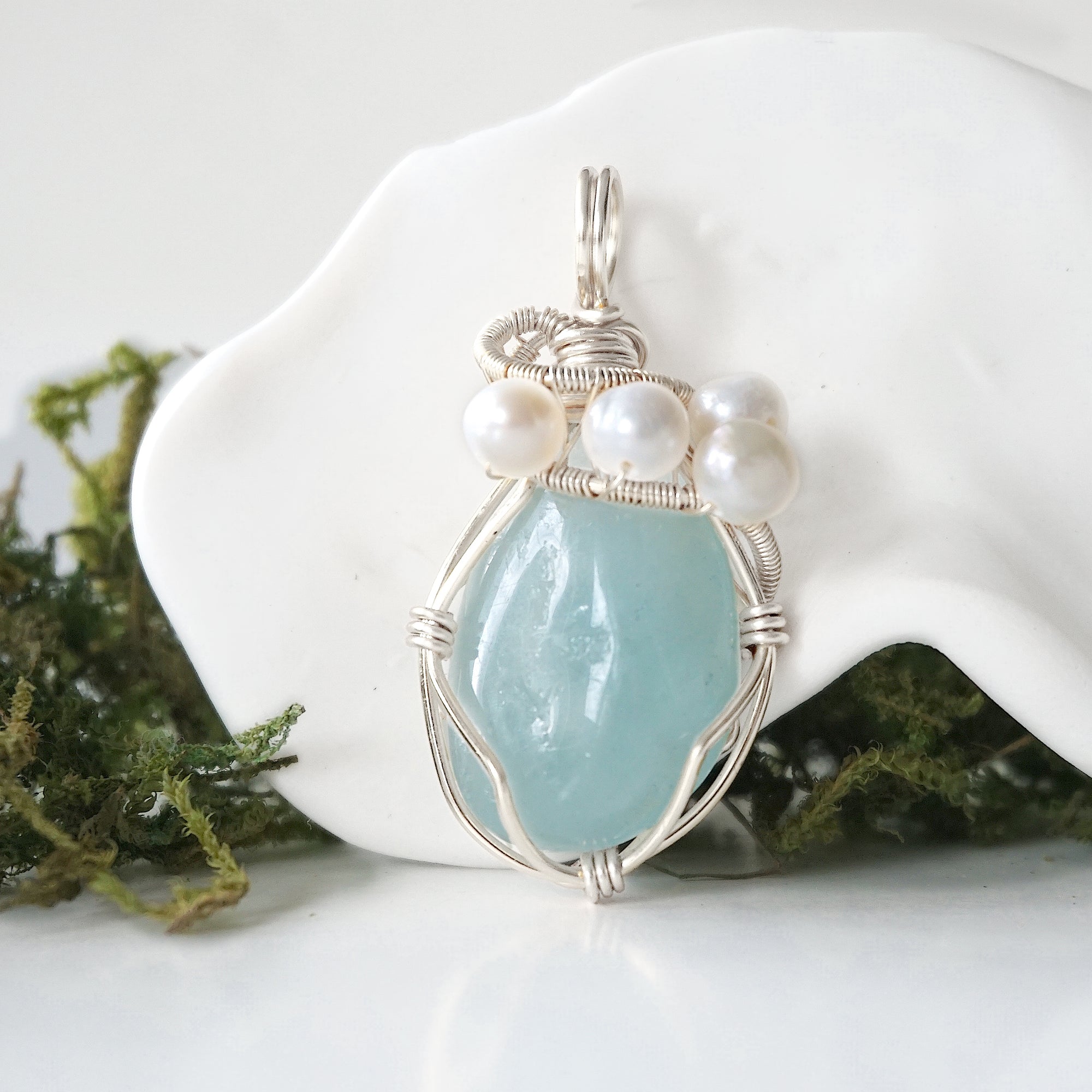 Detailed front view of silver wire wrapped aquamarine and freshwater pearl pendant, unique artisan necklace
