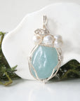 Detailed front view of silver wire wrapped aquamarine and freshwater pearl pendant, unique artisan necklace