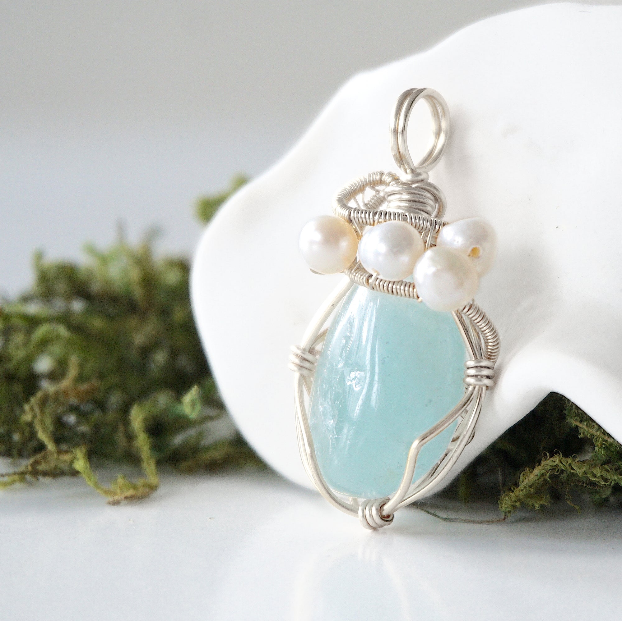 Side angle of handmade aquamarine and freshwater pearl pendant necklace, silver wire wrapped jewelry