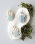 Three silver wire wrapped aquamarine and freshwater pearl pendants showing natural stone variation, artisan jewelry for women