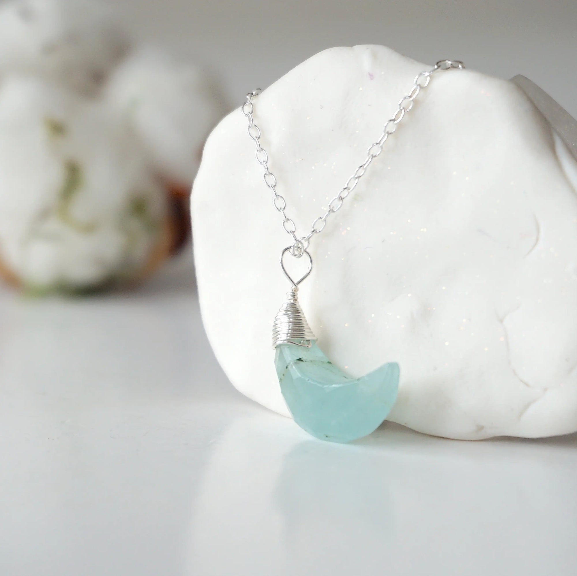 Left side angle of aquamarine moon necklace for women, detailed wire wrapping, sterling silver