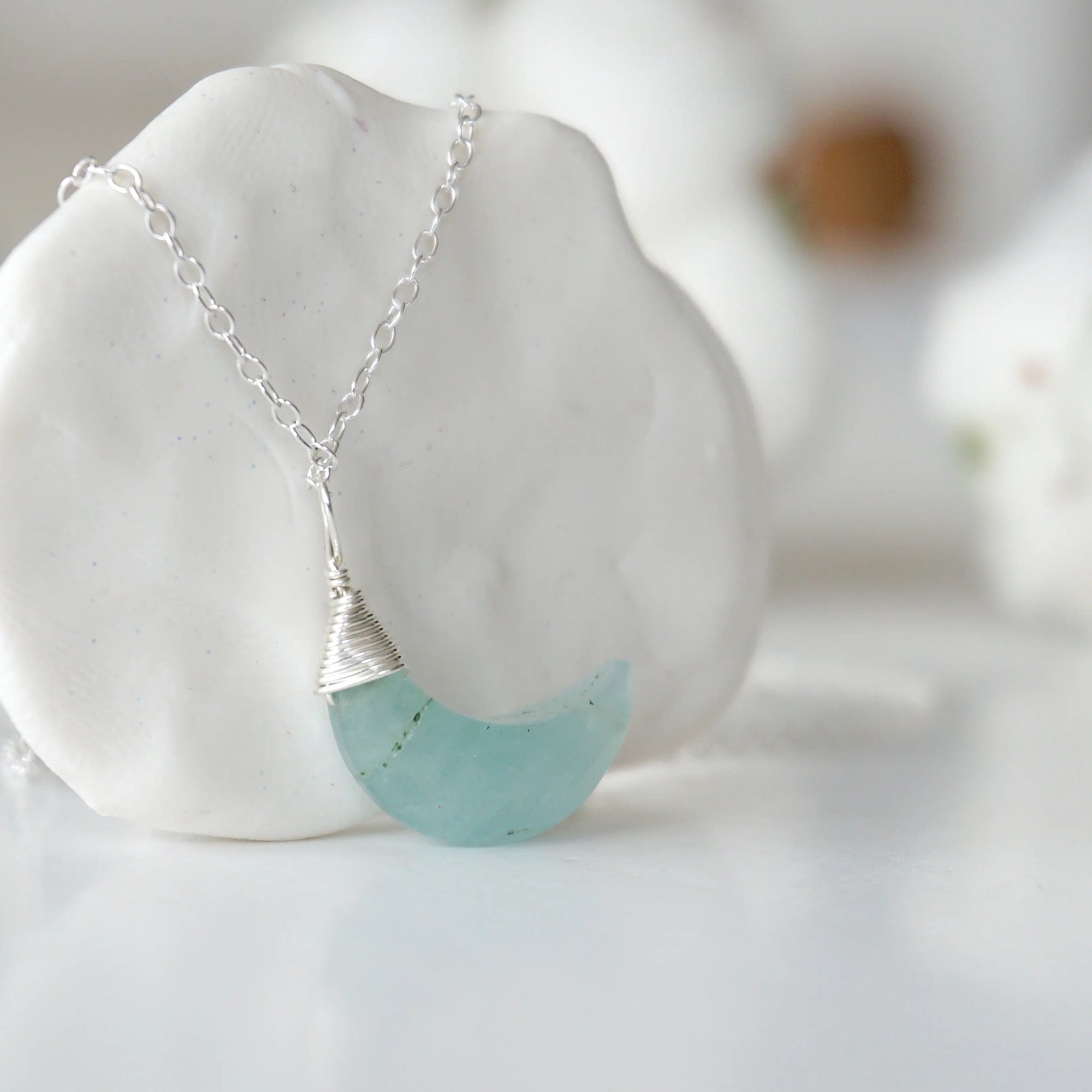 Right side angle of aquamarine moon necklace for women, minimalist wire wrapped, sterling silver
